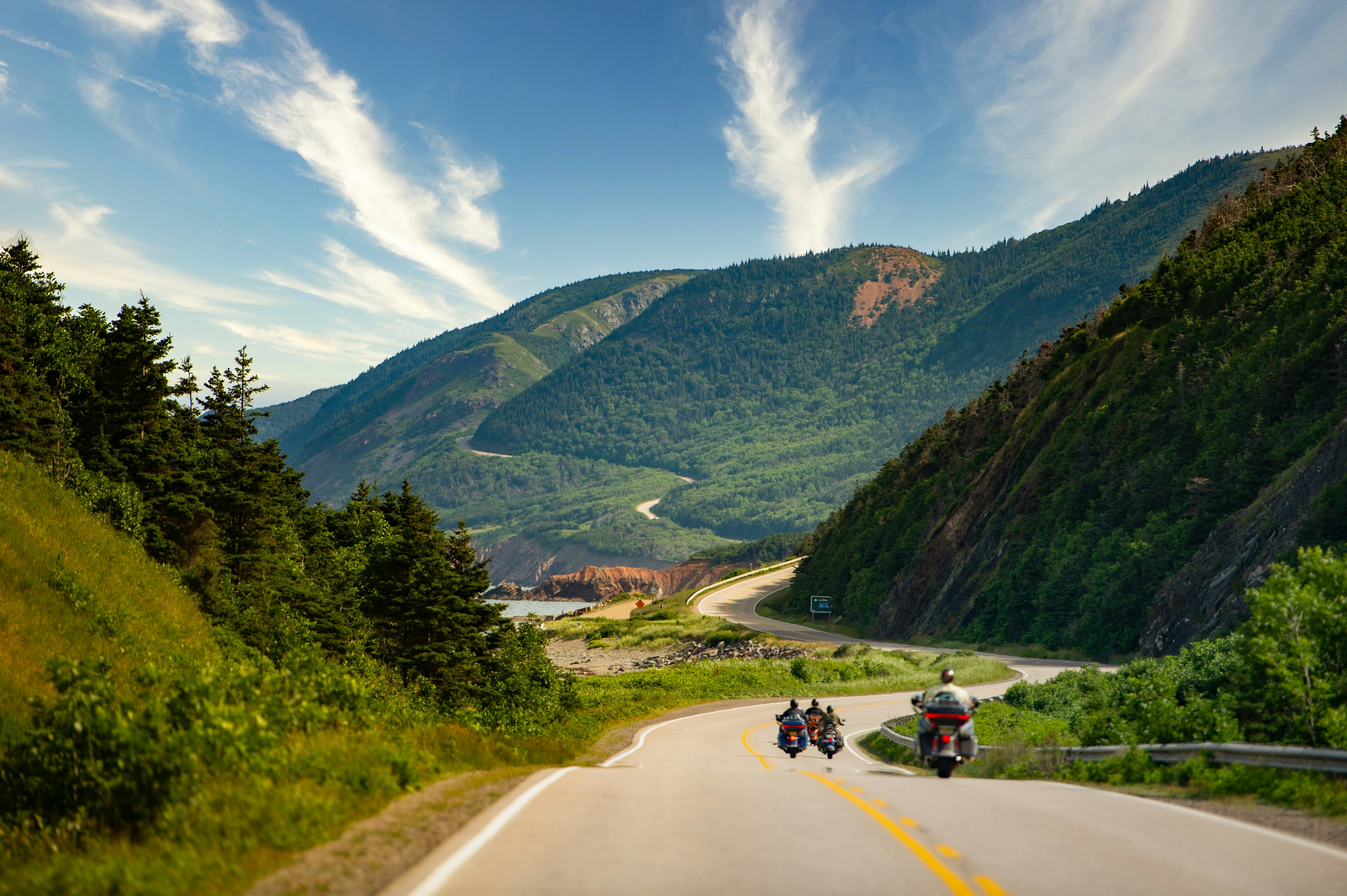 Motorcycles riding on the Cabot Trail in Cape Breton Highlands National Park, Nova Scotia, Canada on a summer day