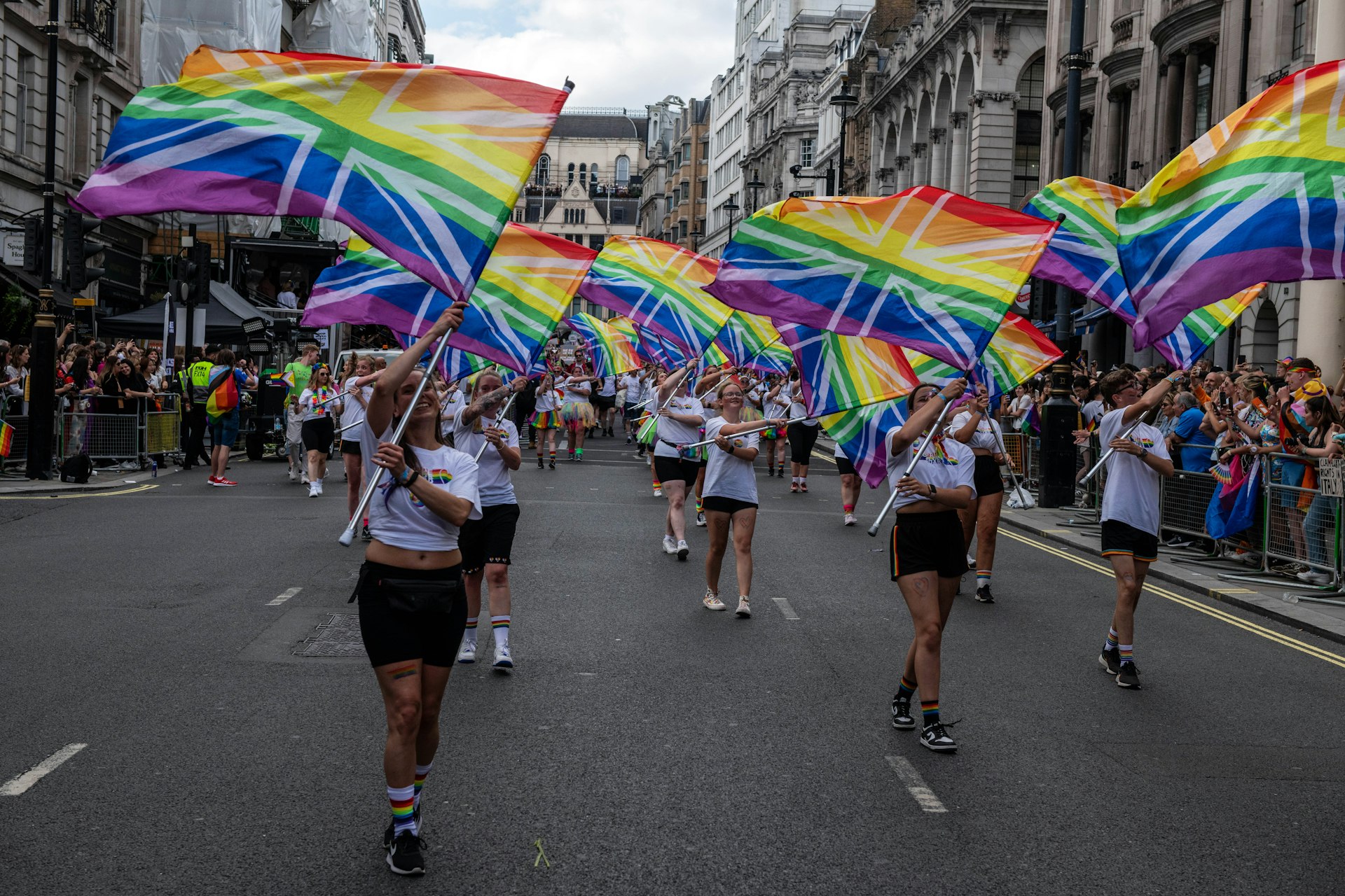 Participants carry rainbow flags with the Union Jack superimposed at the Pride march, London, England, United Kingdom