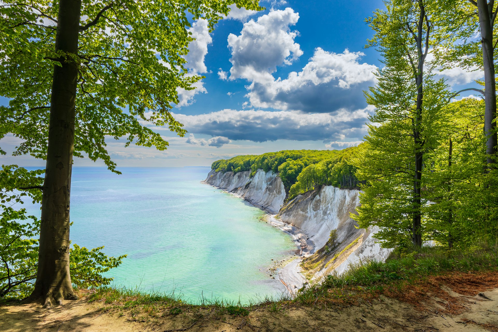 A series of white cliffs leading down to a beach