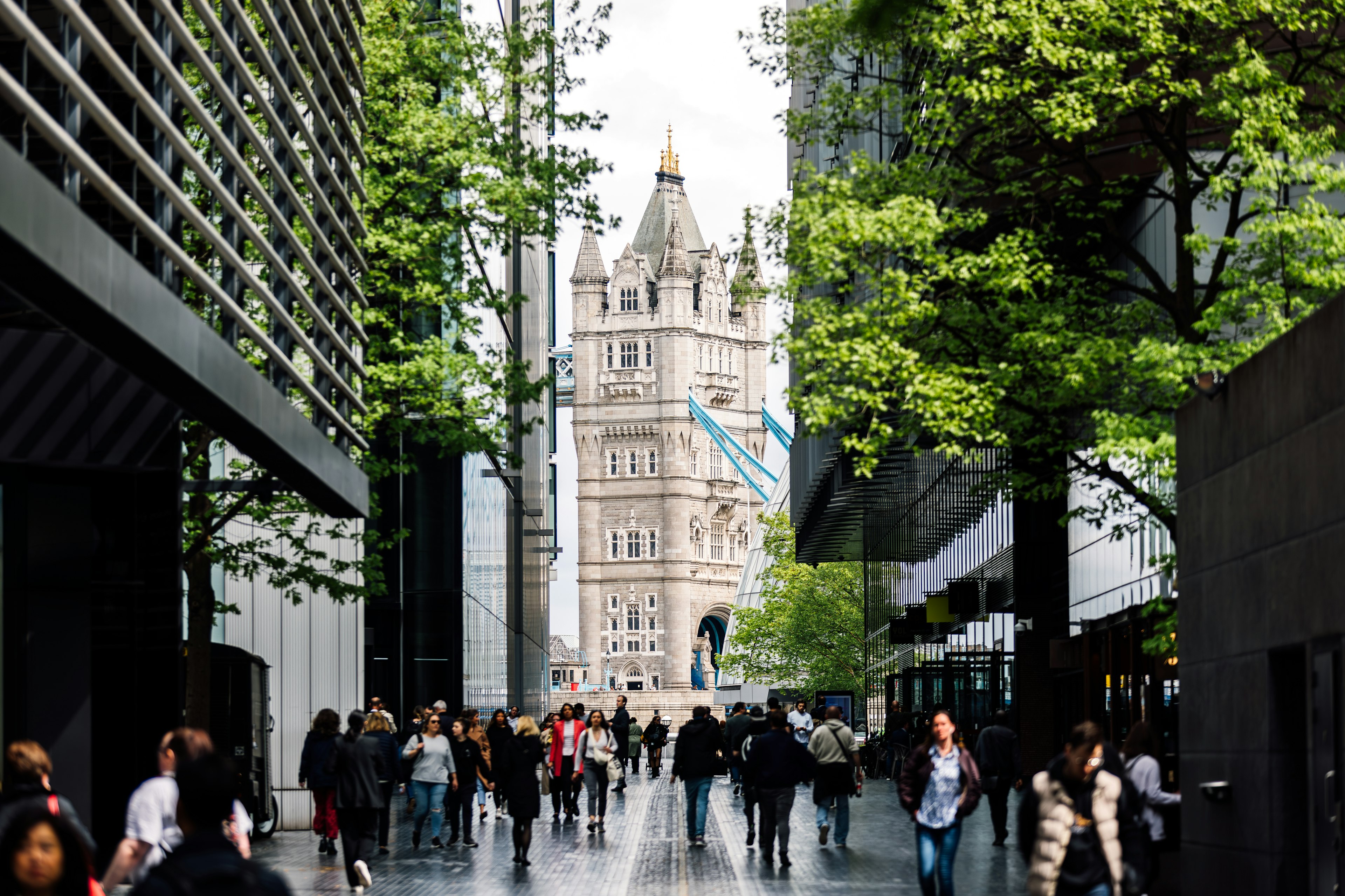 A gothic Victorian bridge structure contrasting with modern glass-fronted buildings