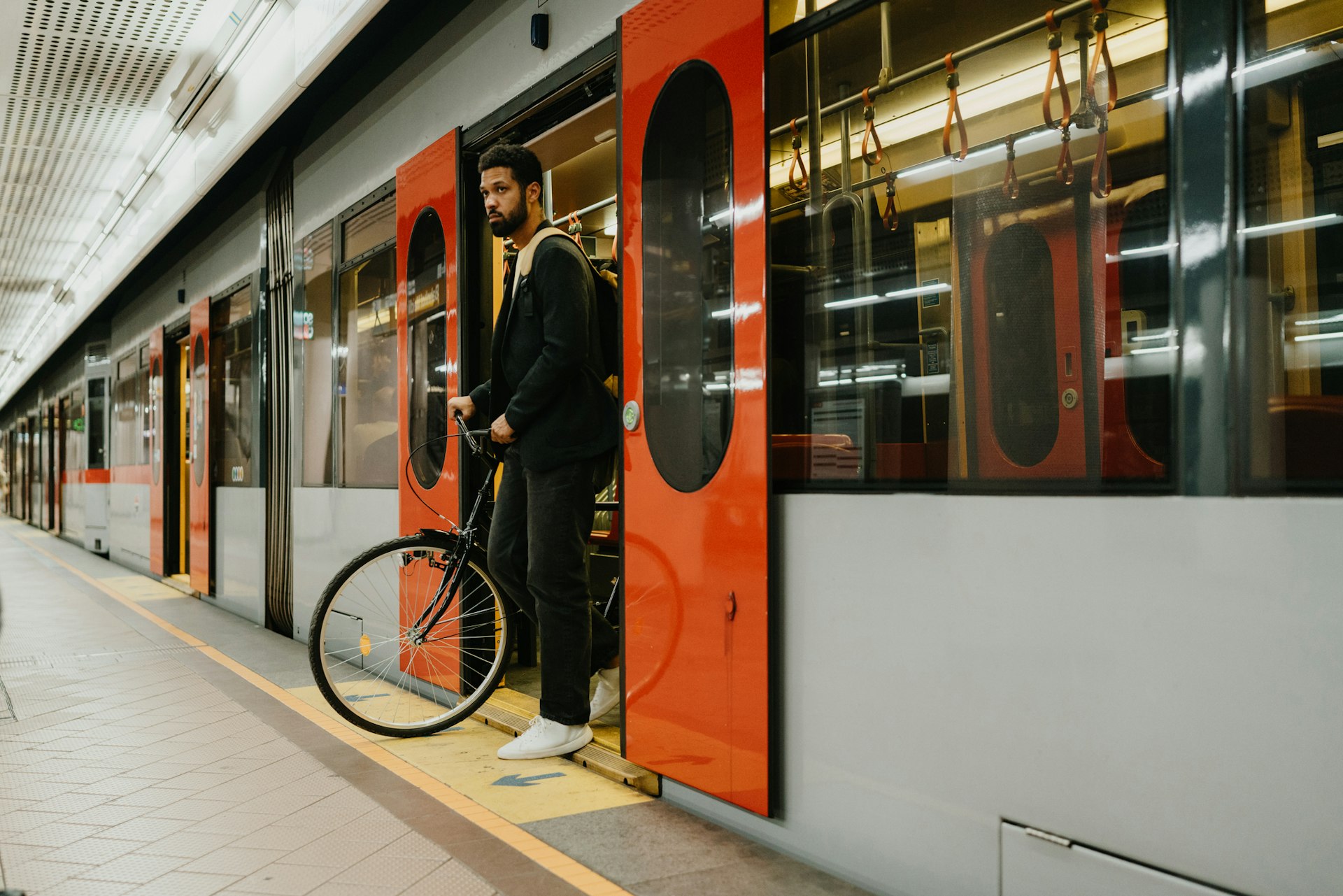 A man stepping off a train with his bike in Austria