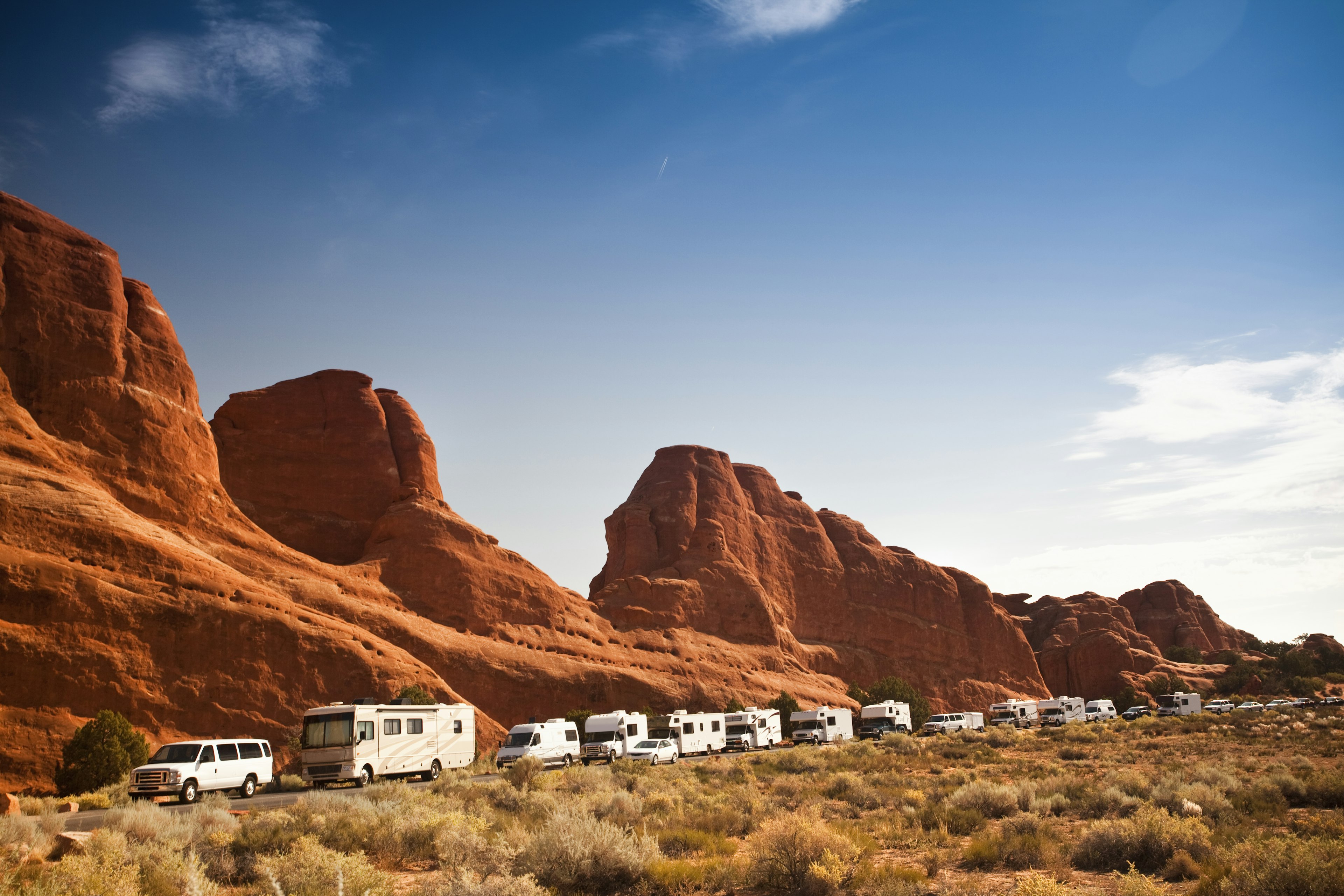 Crowded motor home campers on vacation in the southwest USA red rock landscape in Arches National Park near Moab Utah