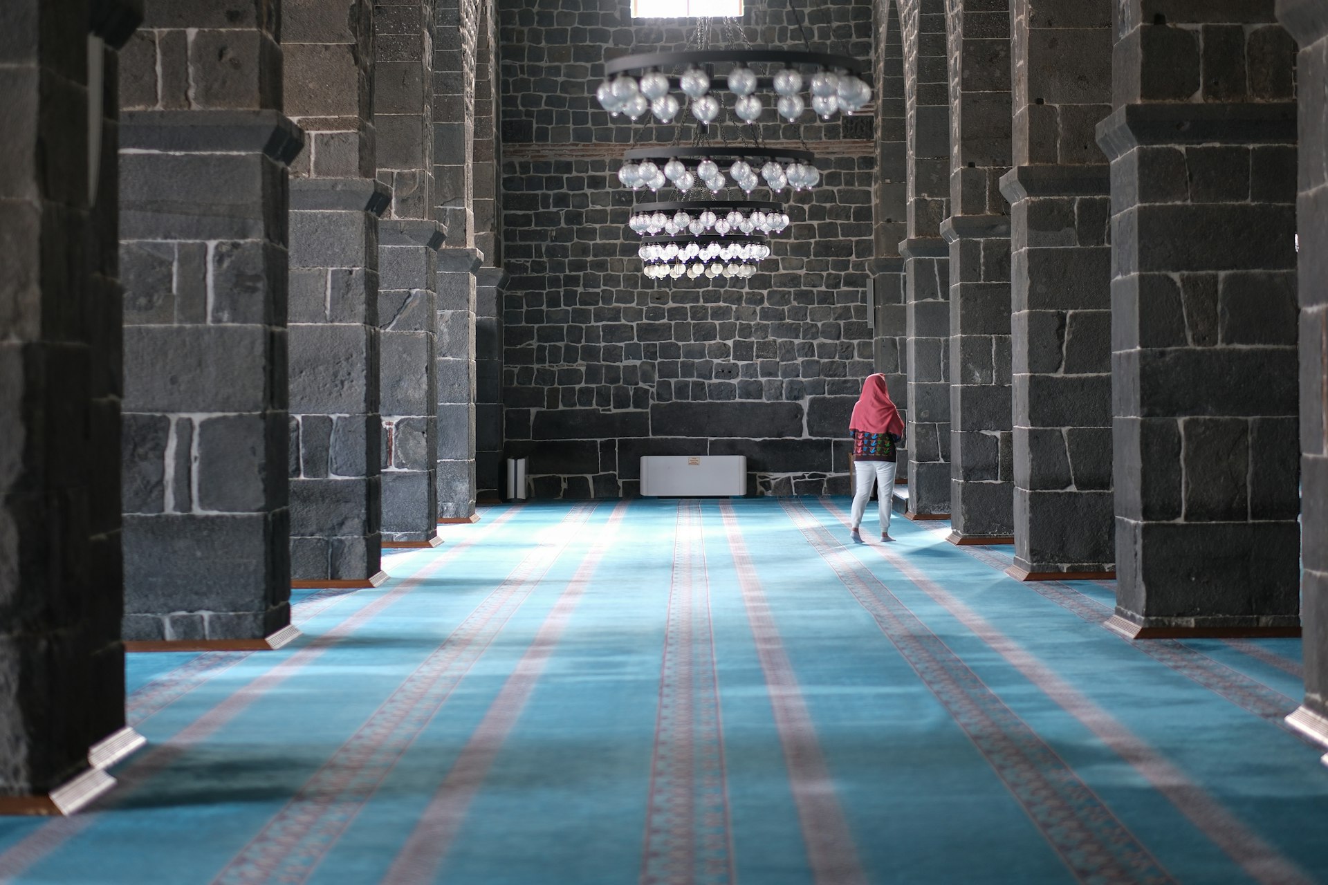 Woman explores the interior of Diyarbakır's Great Mosque, Turkey