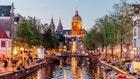 2154447062
Red Light District with crowds of people and Basilica of Saint Nicholas illuminated at dusk, Amsterdam, Netherlands - stock photo