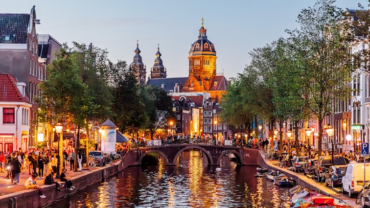 2154447062
Red Light District with crowds of people and Basilica of Saint Nicholas illuminated at dusk, Amsterdam, Netherlands - stock photo