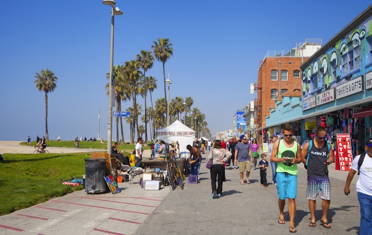 Venice Beach, Los Angeles, USA- February 23, 2014: Tourists and locals along the famous Venice Beach promenade.