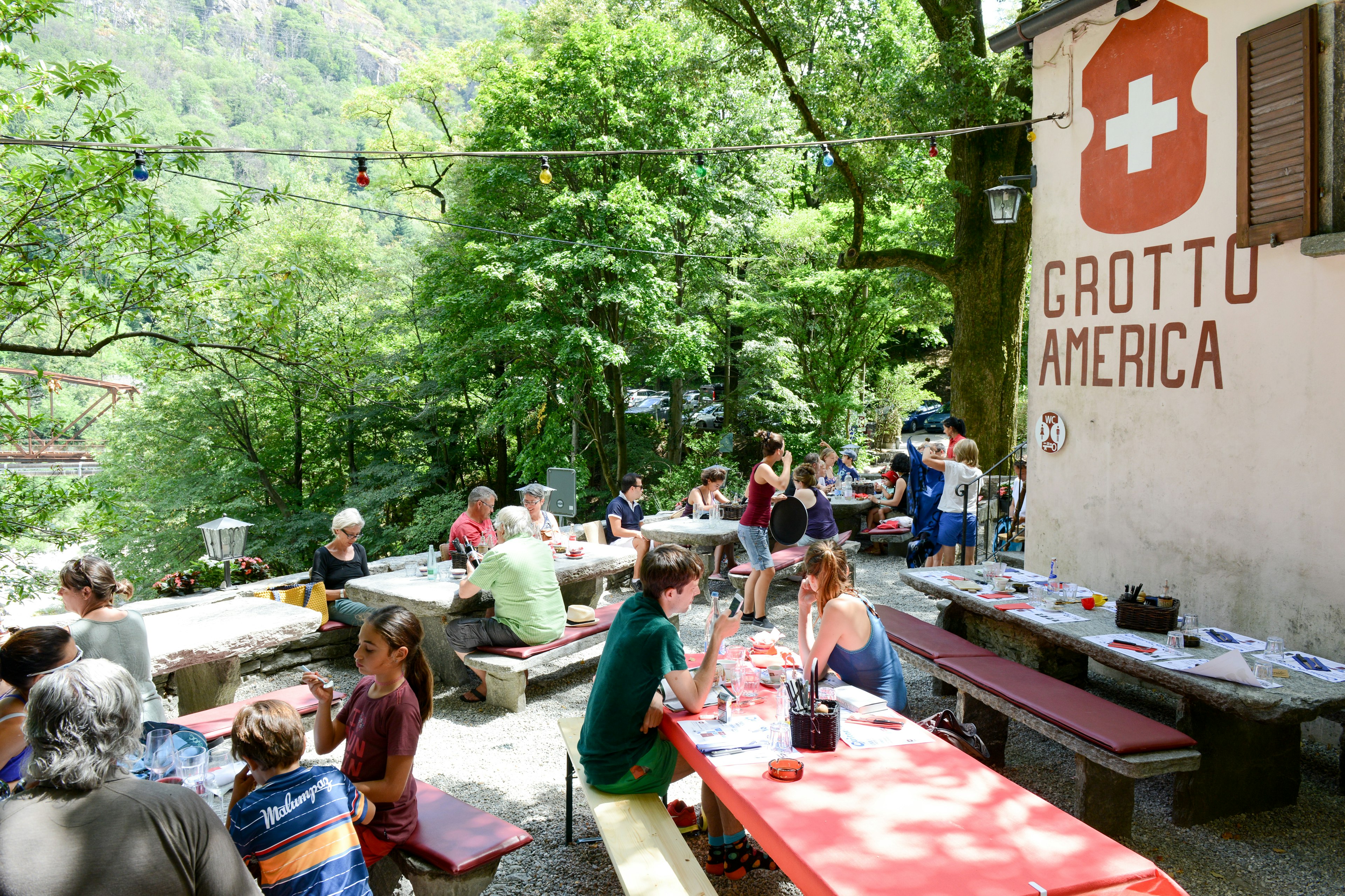 Diners in the garden of a grotto restaurant in Ticino, Switzerland