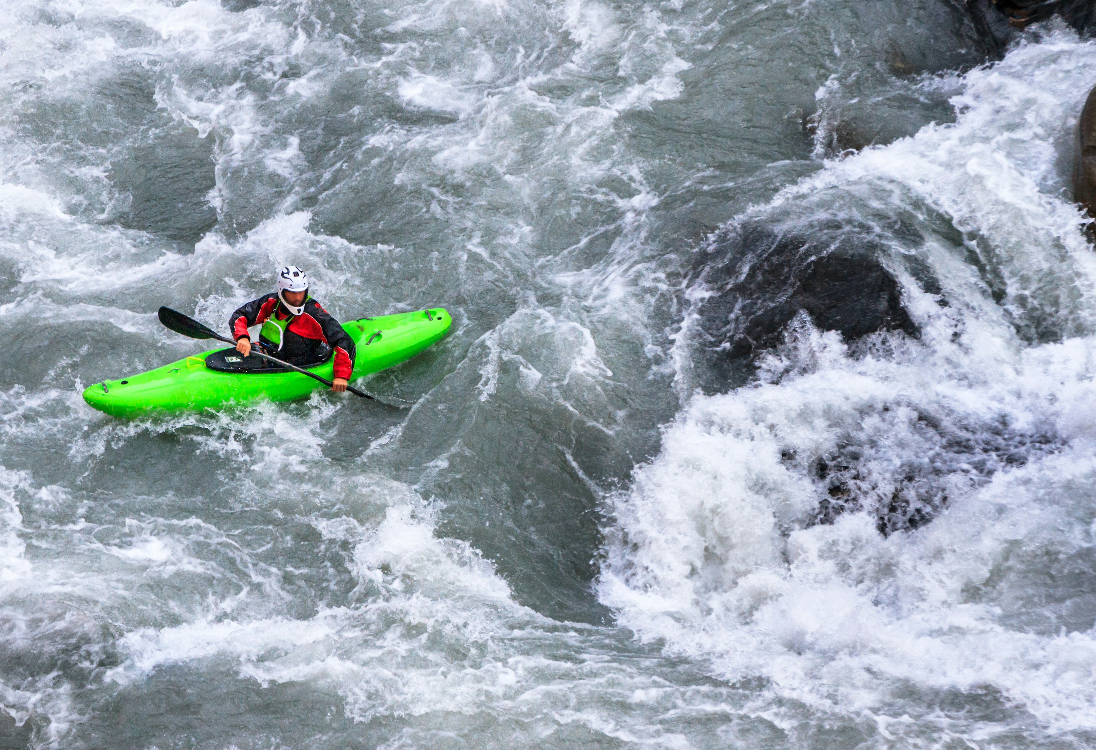 A person kayaking on white water on the Kali Gandaki River, near Tatopani, Annapurna Conservation Area, Sindhupalchok District, Nepal