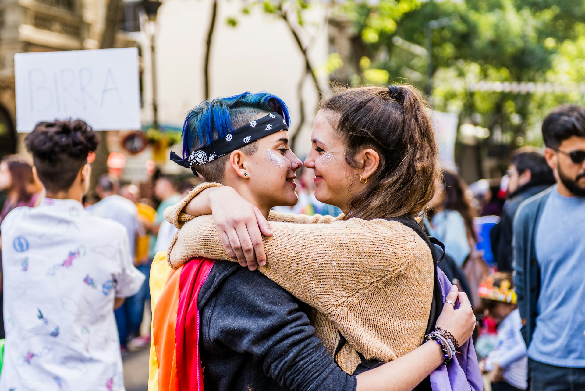 Two women are hugging and smiling at each other during a Pride event in Buenos Aires