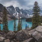 Hiker stands on top of rocks near Moraine Lake with the Canadian Rockies in the background.
1087161748
Non-Urban Scene, Alberta, Beauty In Nature, Canadian Rockies, Wood, Incidental People, Banff National Park, Day, Canada, Mountain, Majestic, Lake, Woodland, Horizontal, Color Image, Photography, Nature, Outdoors, Scenics - Nature, Canada Place, Moraine Lake, Landscape - Scenery