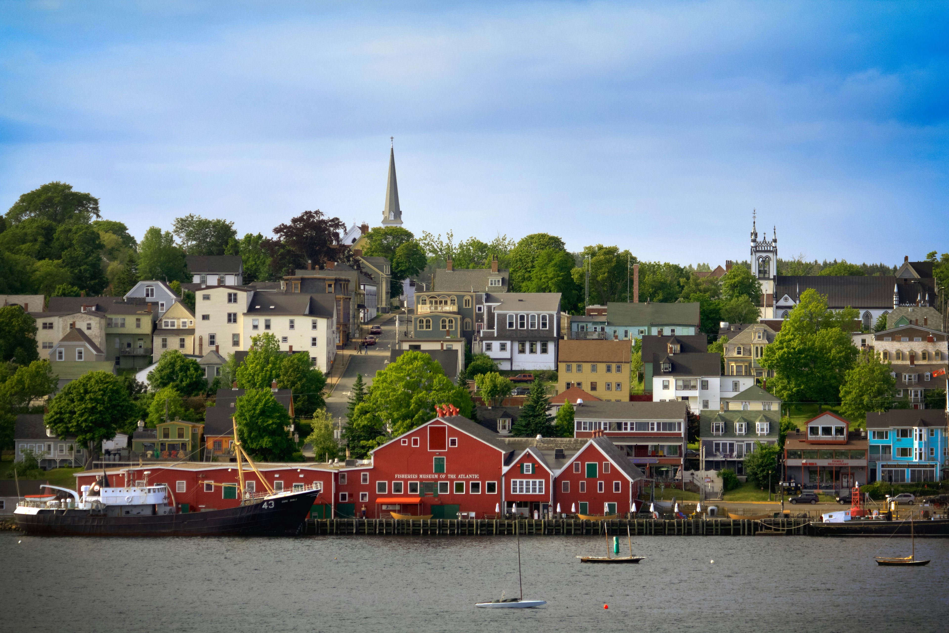 A waterfront lined with buildings including a red fishing museum