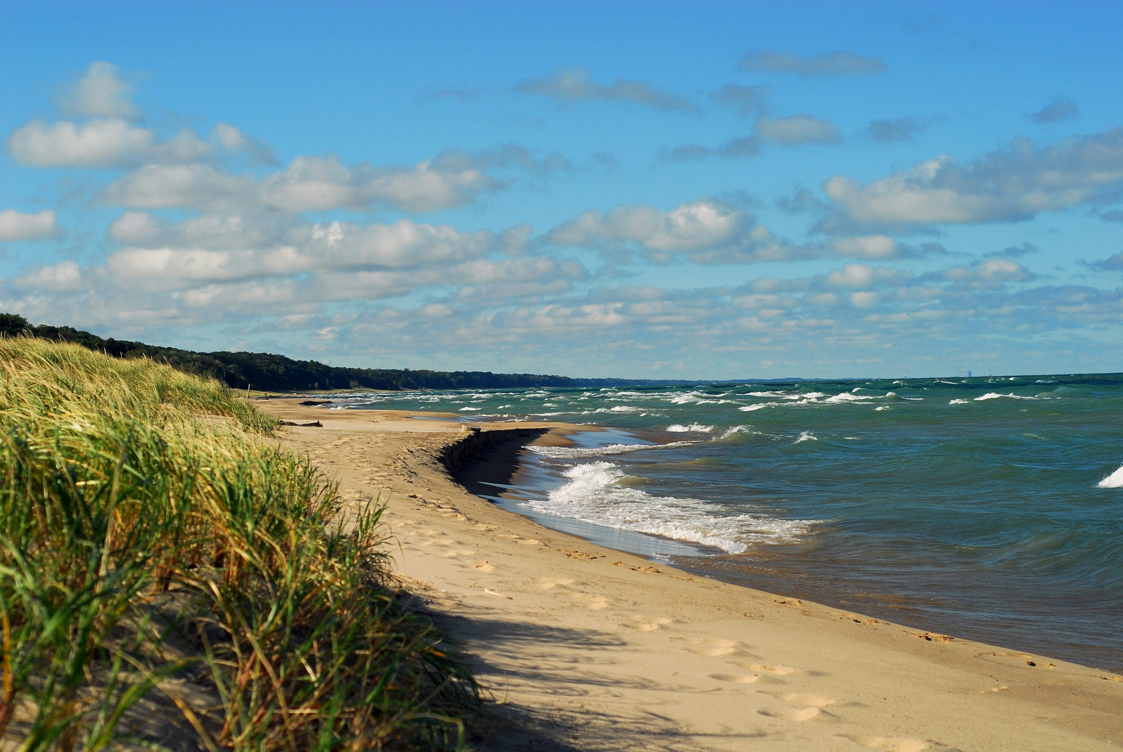 An empty beach lapped by strong waves