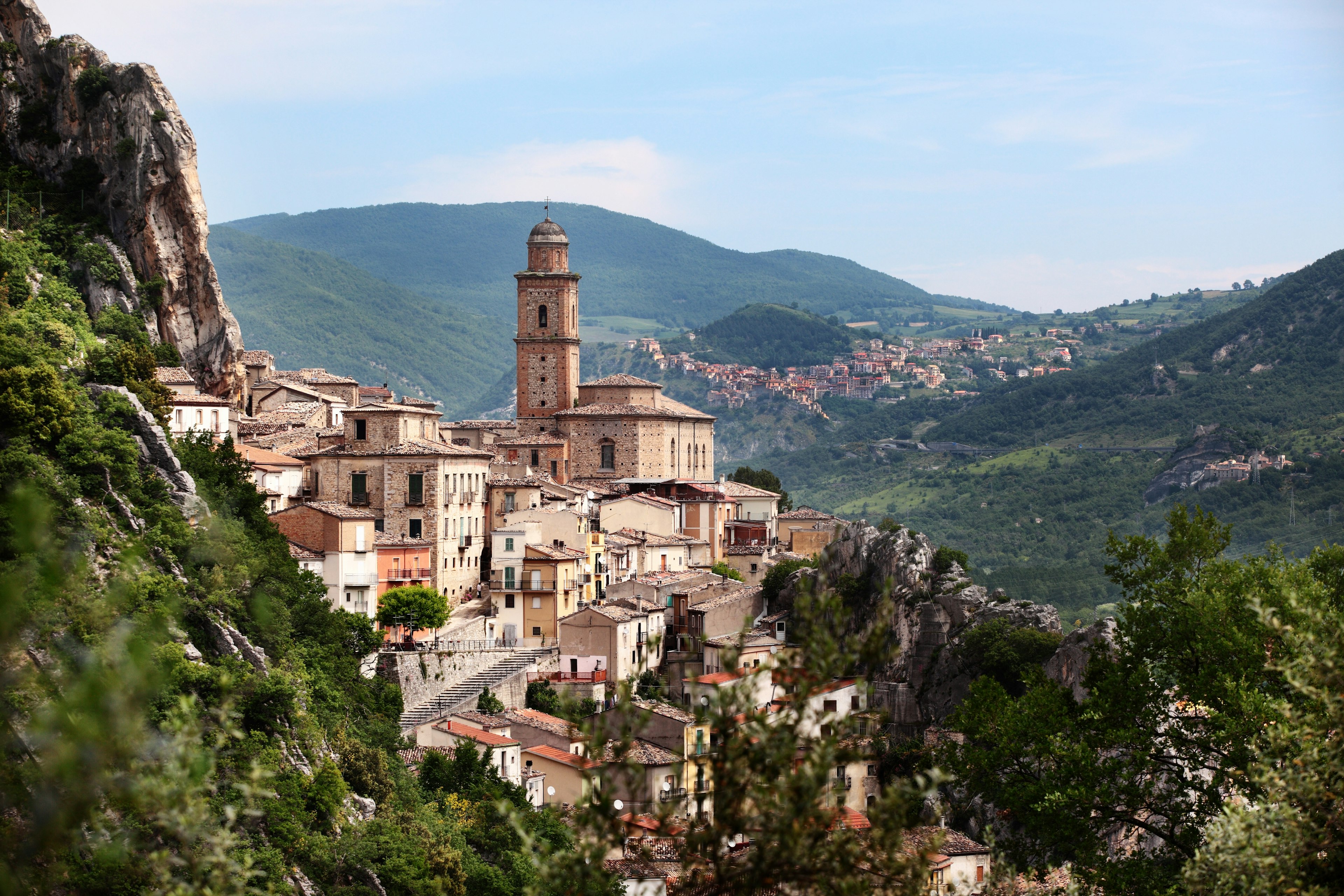 A charming medieval village is set in a beautiful mountain range in Italy.