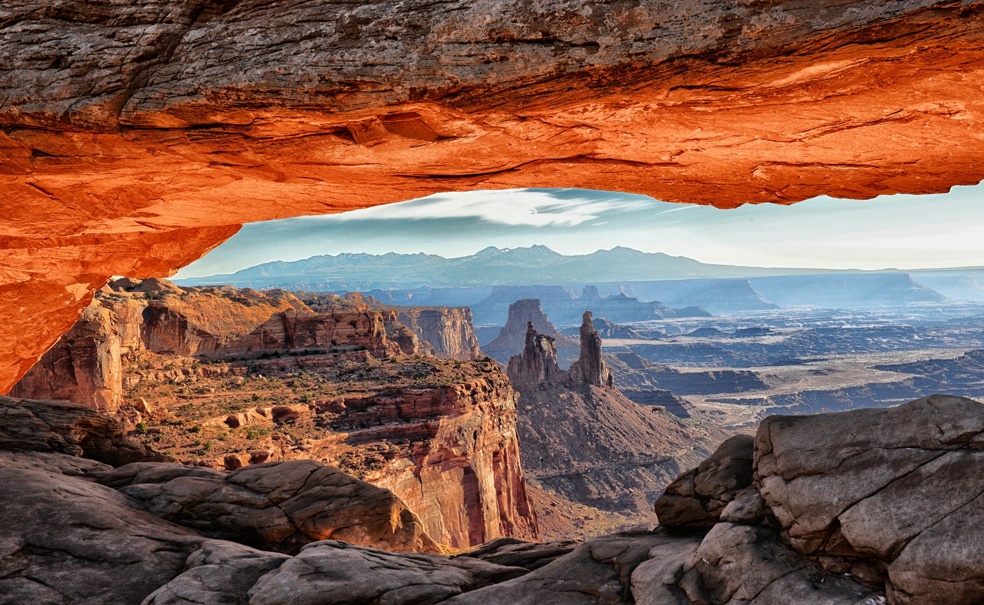 A view through the Mesa Arch in Canyonlands National Park at sunrise