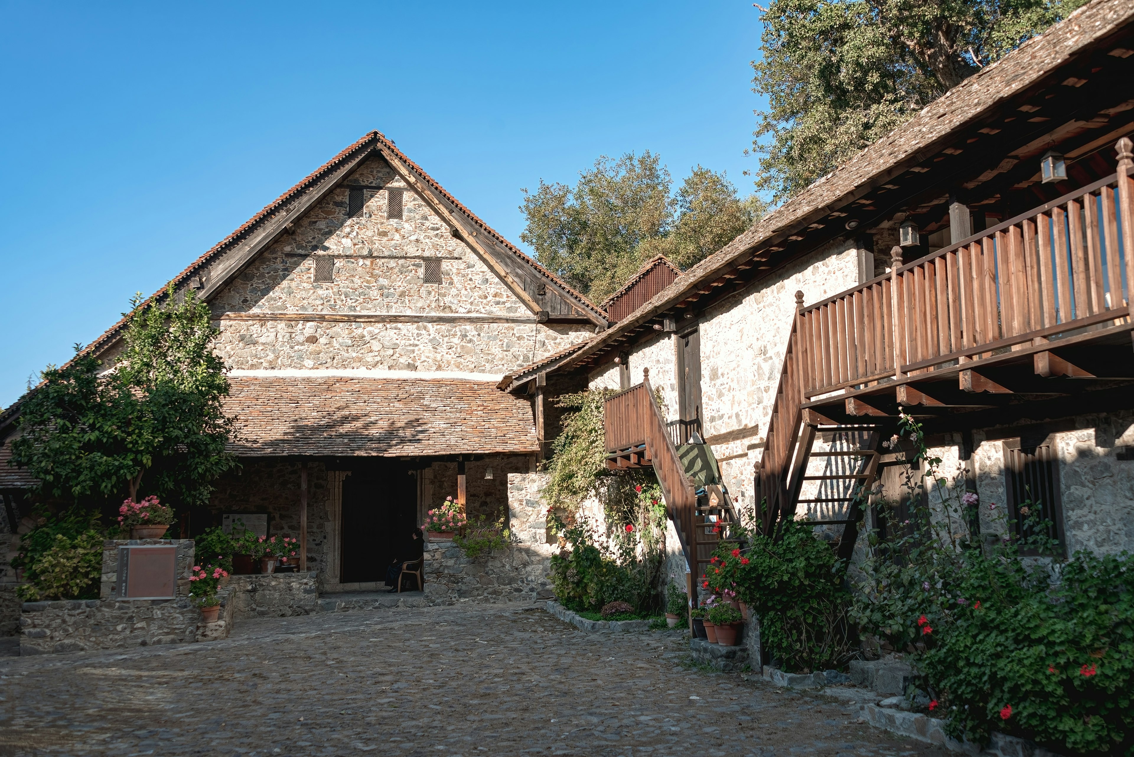 A rustic stone building with a wooden roof in Cyprus.