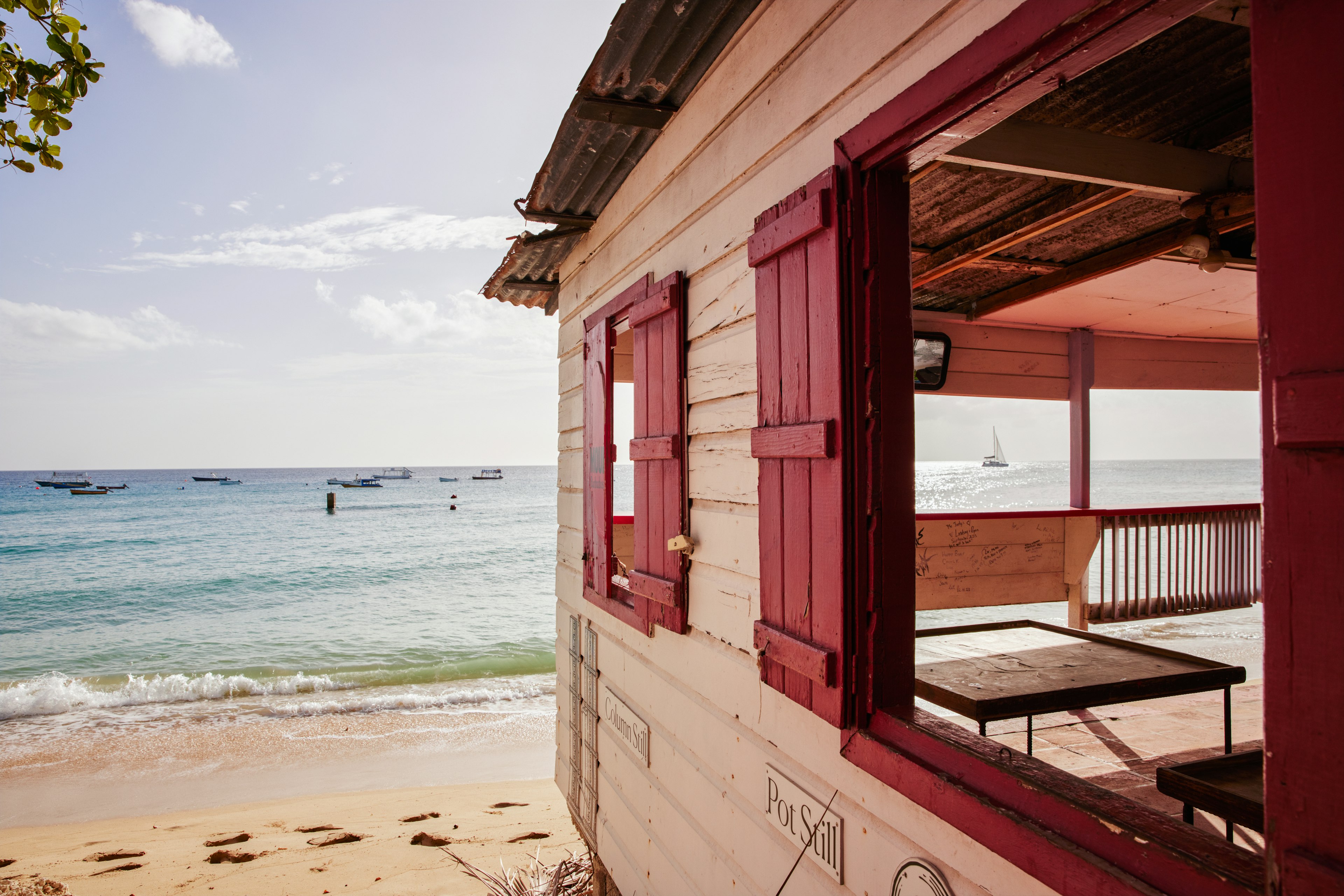 A seaside bar looking out at sail boats