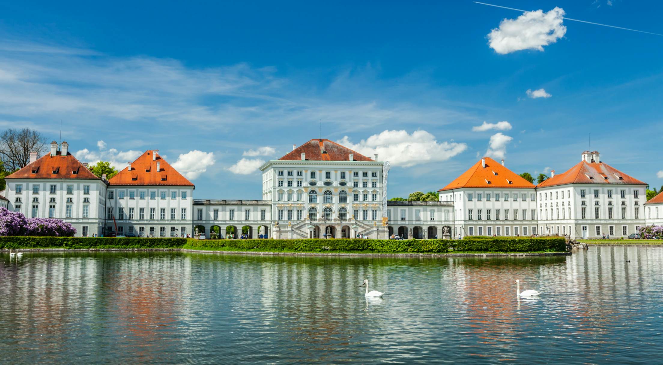 Beautiful building on a lake with swans in Munich