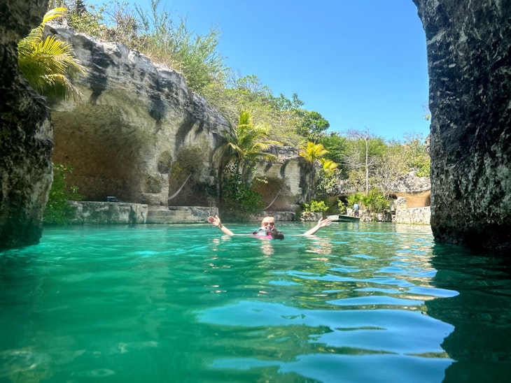 Lonely Planet editor Melissa Yeager swimming in the river surrounding the resort at Hotel Xcaret México in Playa del Carmen.