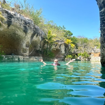 Lonely Planet editor Melissa Yeager swimming in the river surrounding the resort at Hotel Xcaret México in Playa del Carmen.