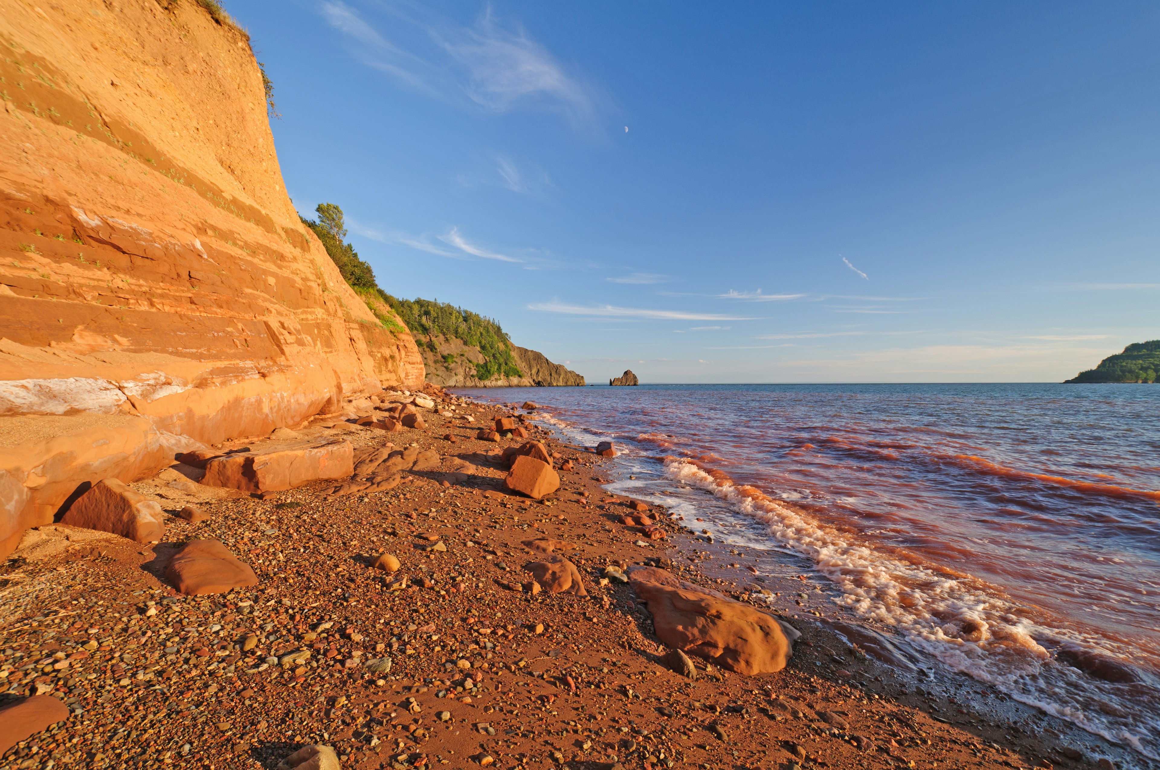 A beach with distinctive orange sand