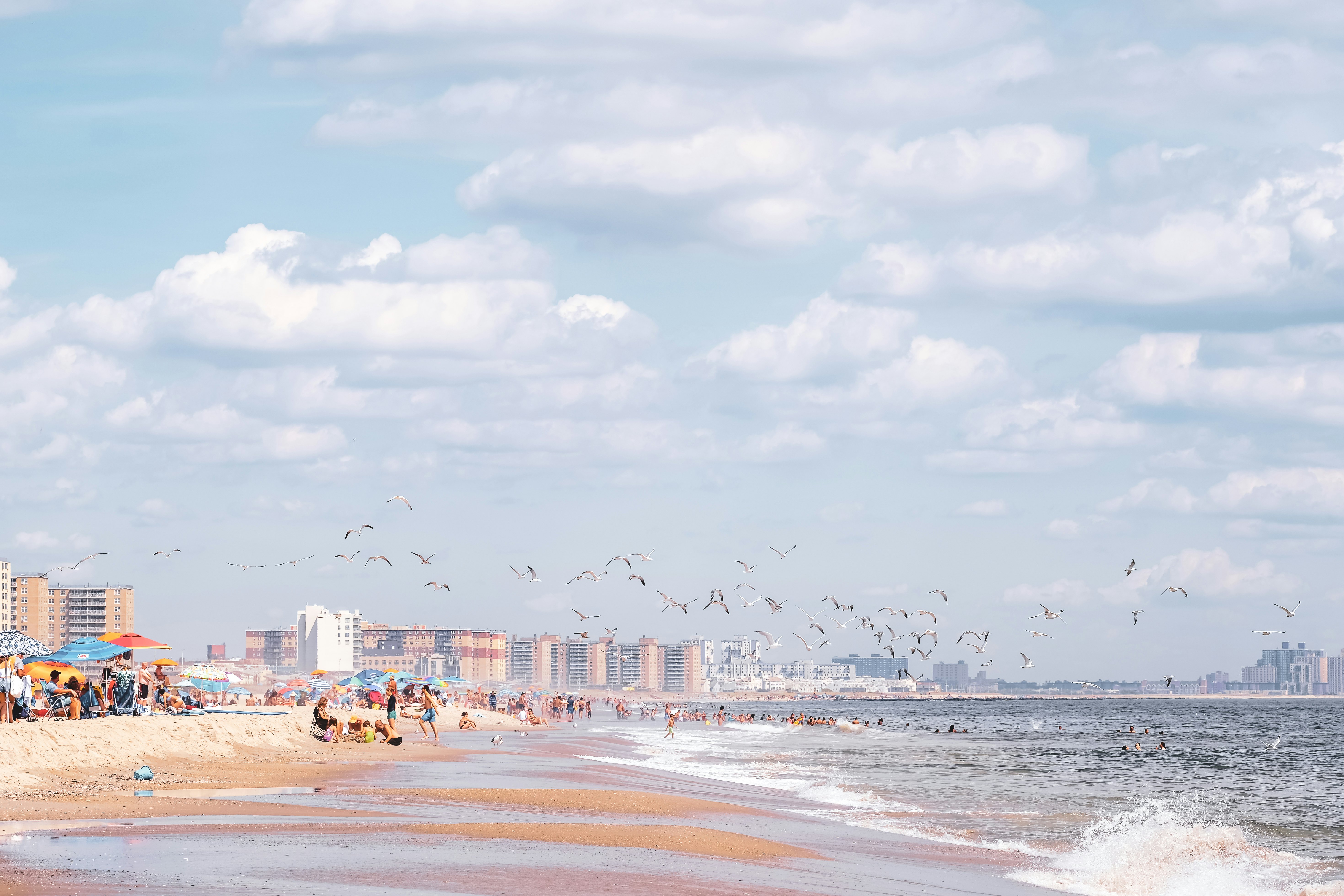 Rockaways, Queens, New York beach front and ocean during summer. Blue skies and white sand.