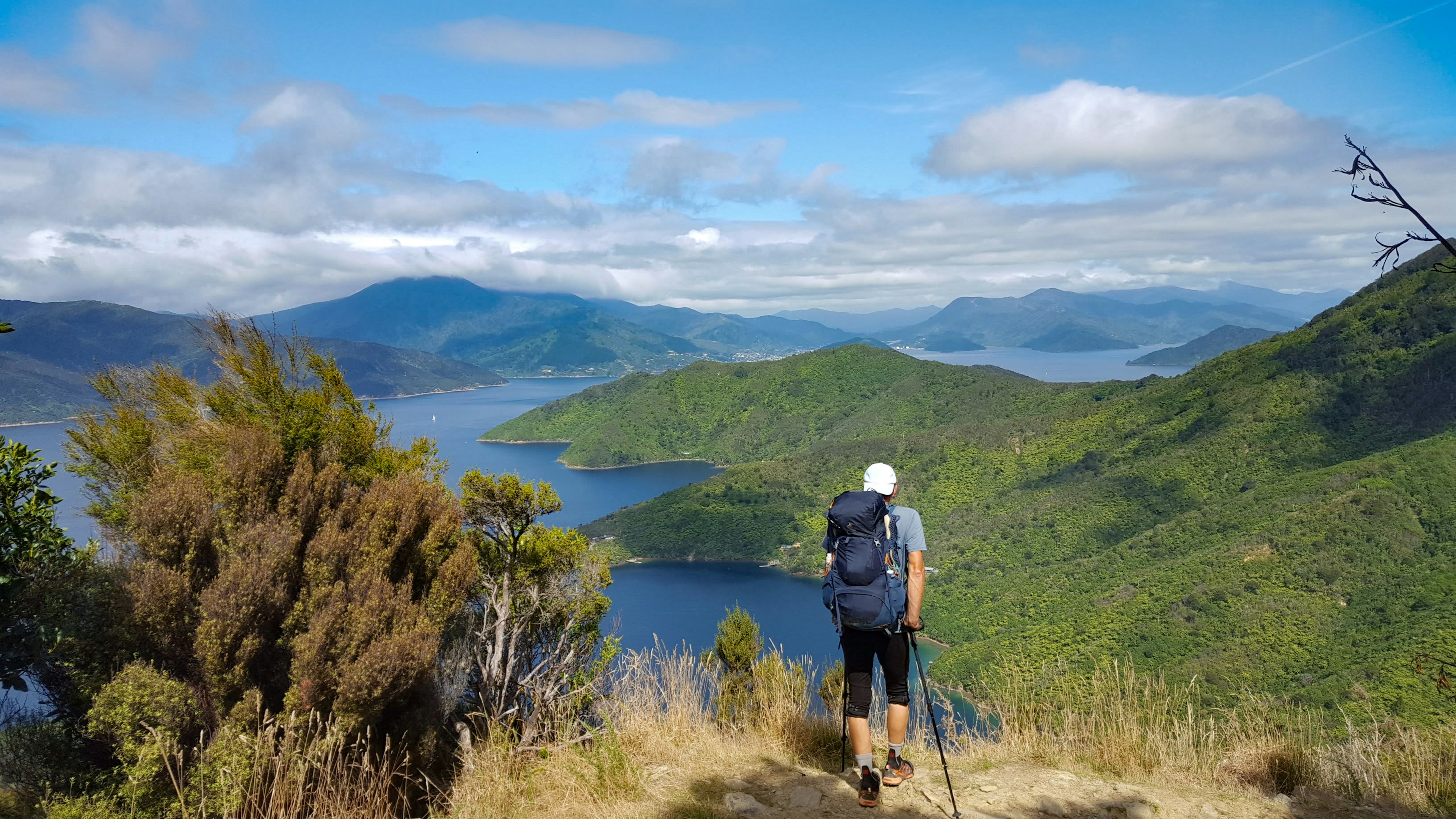 A hiker looking out over a peninsula surrounded by ocean