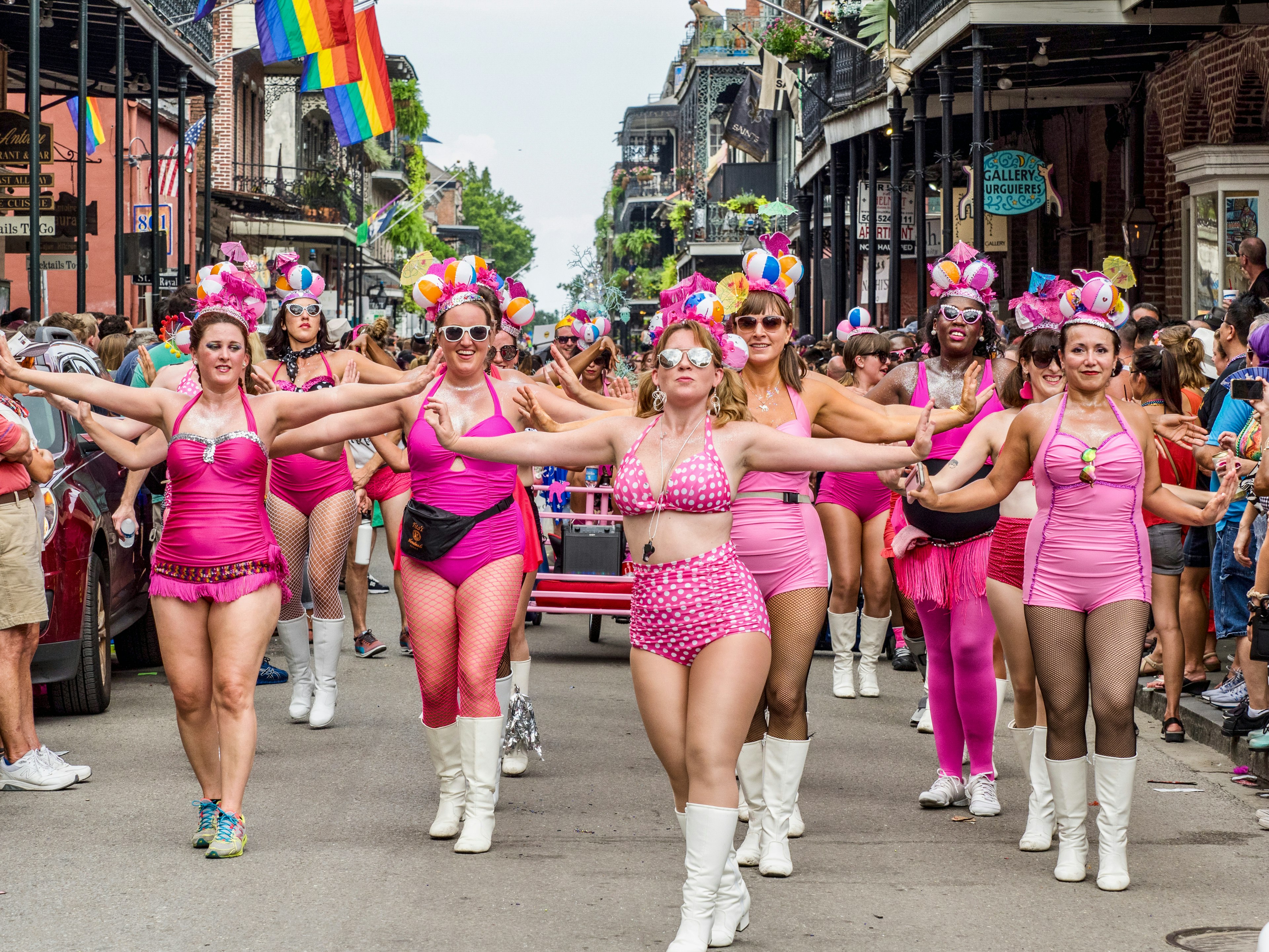 Female revelers march through the French Quarter during the Pride parade, New Orleans, Louisiana, USA