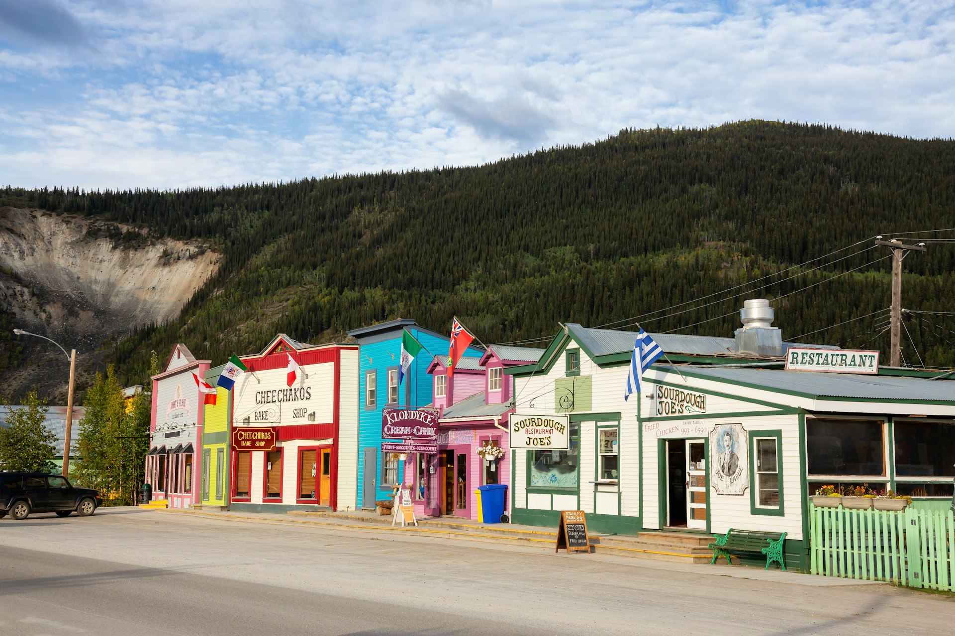 Colorful historic buildings against a mountain backdrop in Dawson City, Yukon, Canada