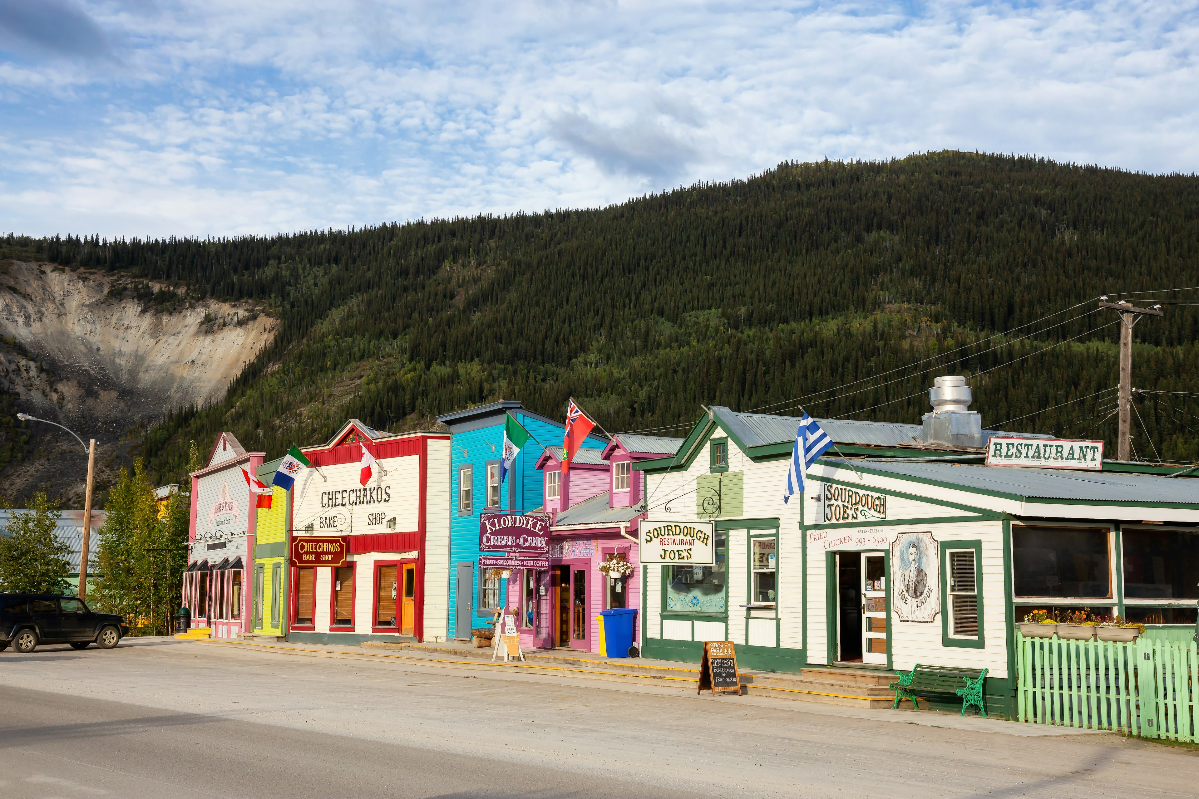 Colorful historic buildings against a mountain backdrop in Dawson City, Yukon, Canada