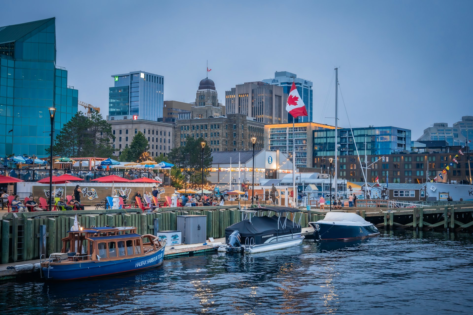 The waterfront boardwalk with the city skyline on a summer evening at dusk, Halifax, Nova Scotia, Canada