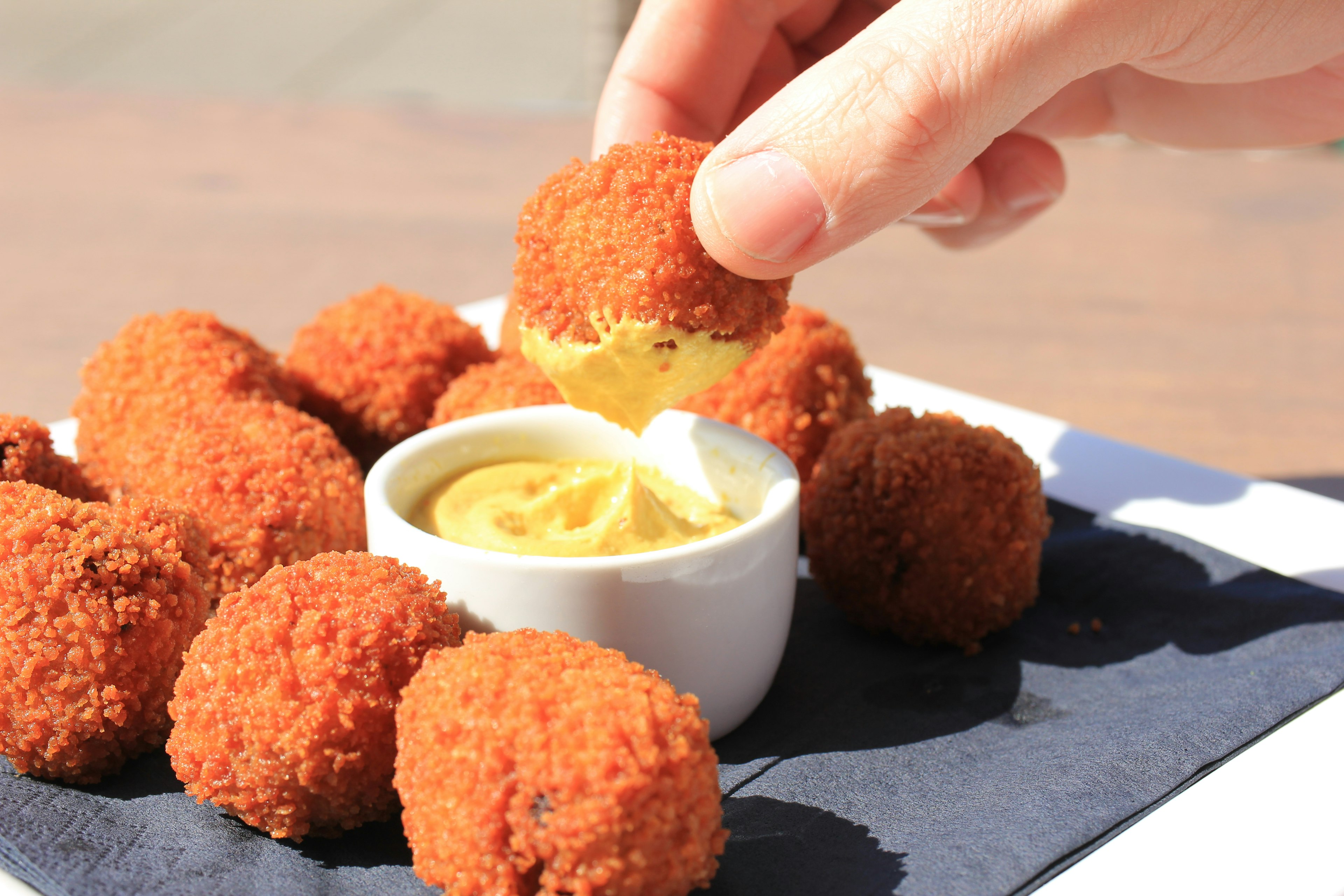 Dutch bitterballen (warm stuffed fried meatballs) served with mustard.