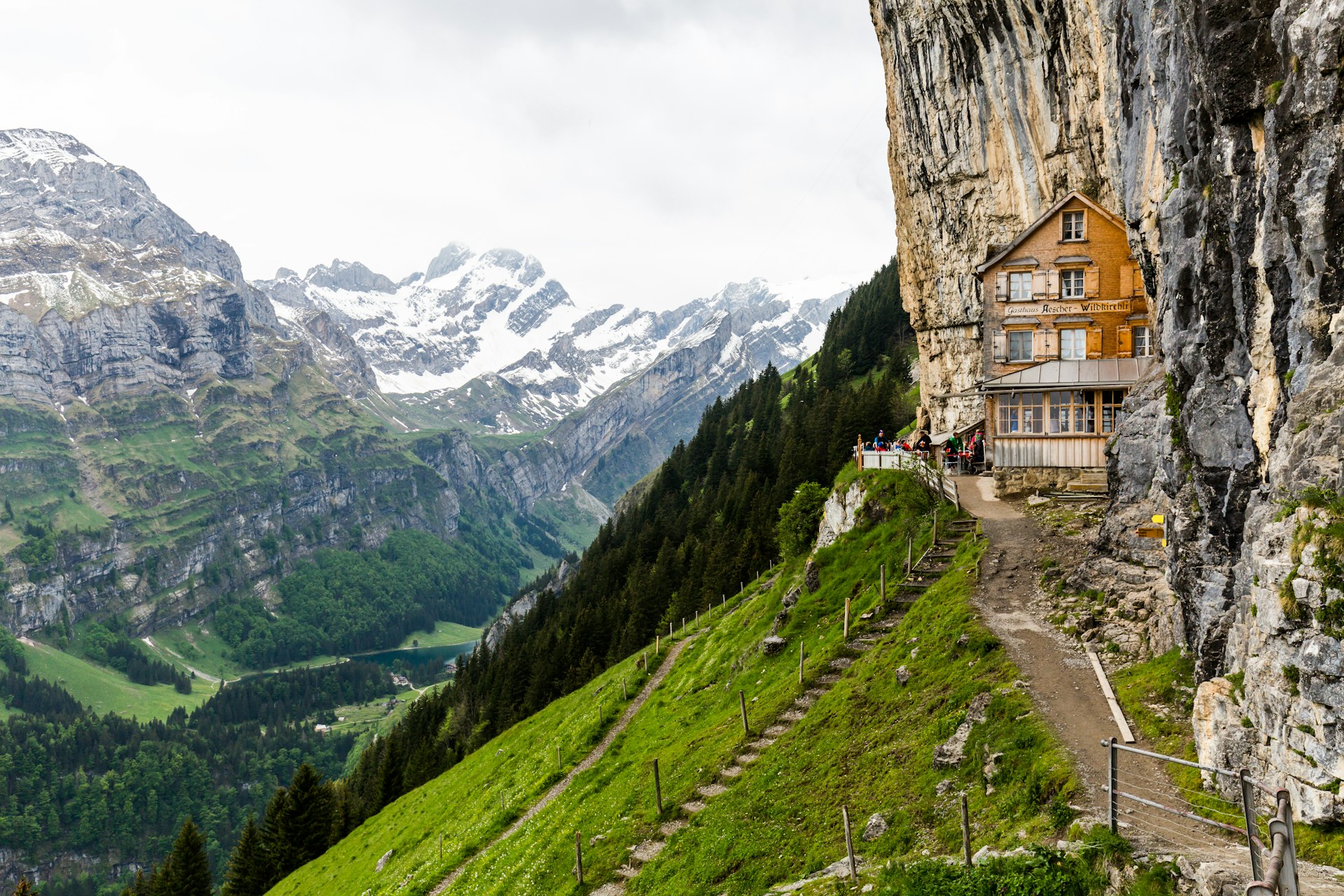 A Swiss building is set back into the mountains of Switzerland. 