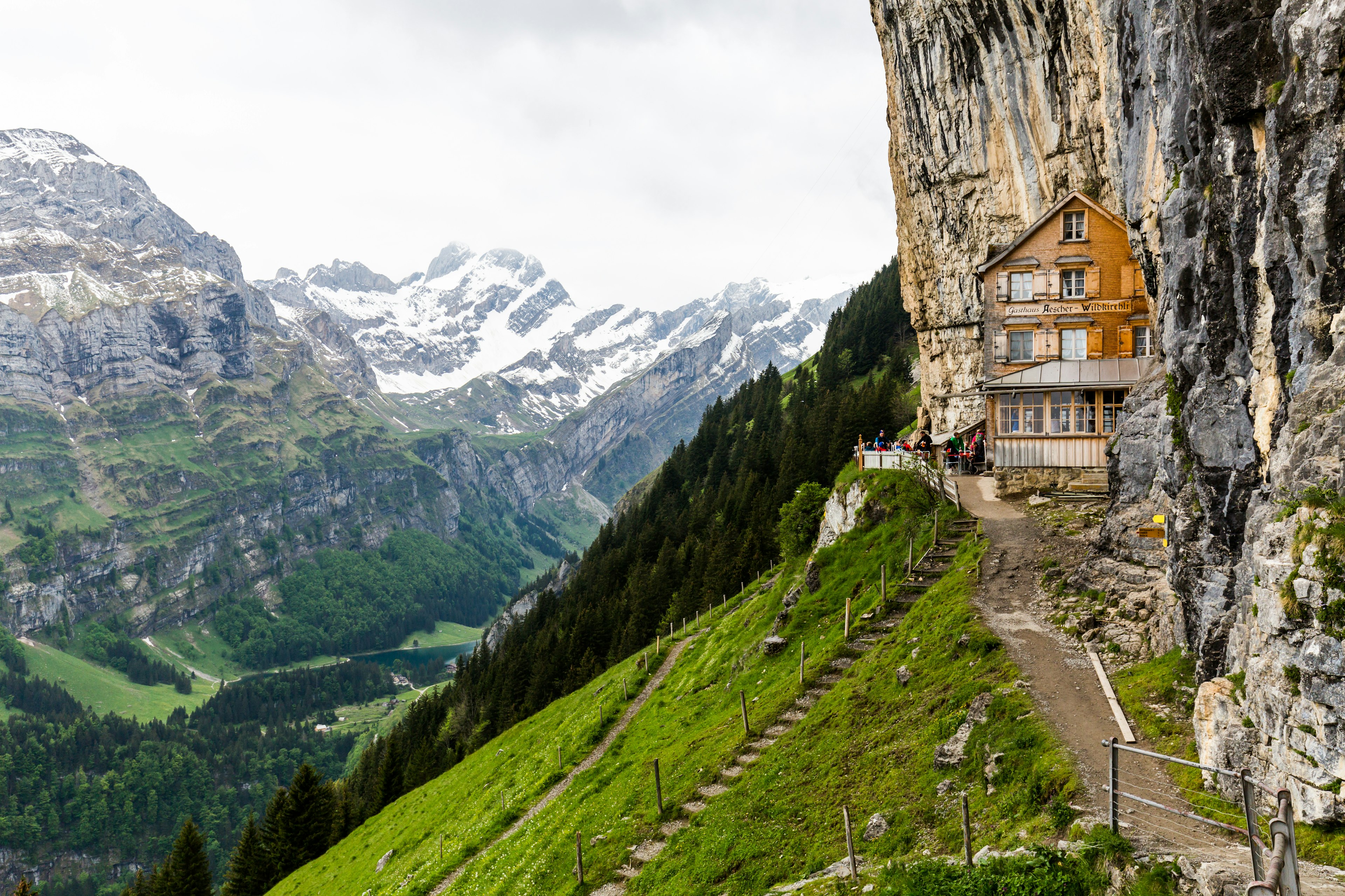 A Swiss building is set back into the mountains of Switzerland.