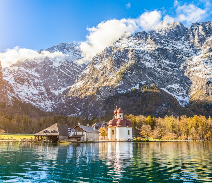 Panoramic view of scenic mountain scenery with Lake Konigssee with famous Sankt Bartholomae pilgrimage church in golden evening light in fall, national park Berchtesgadener Land, Bavaria, Germany.
alpine, alps, attraction, austria, austrian, autumn, baroque, bartholoma, bartholomae, bartholomew, bartholomew's, bavaria, bavarian, bayern, berchtesgaden, berchtesgadener, blue, cathedral, chapel, church, europe, fall, forest, german, germany, hirschau, indian, koenigssee, konigssee, lake, land, landmark, landscape, leaves, mountains, nature, panorama, pilgrimage, reflection, rocks, sankt, sky, snow, st, st., summer, sunset, tourism, tourist, travel, trees, water, watzmann, wilderness