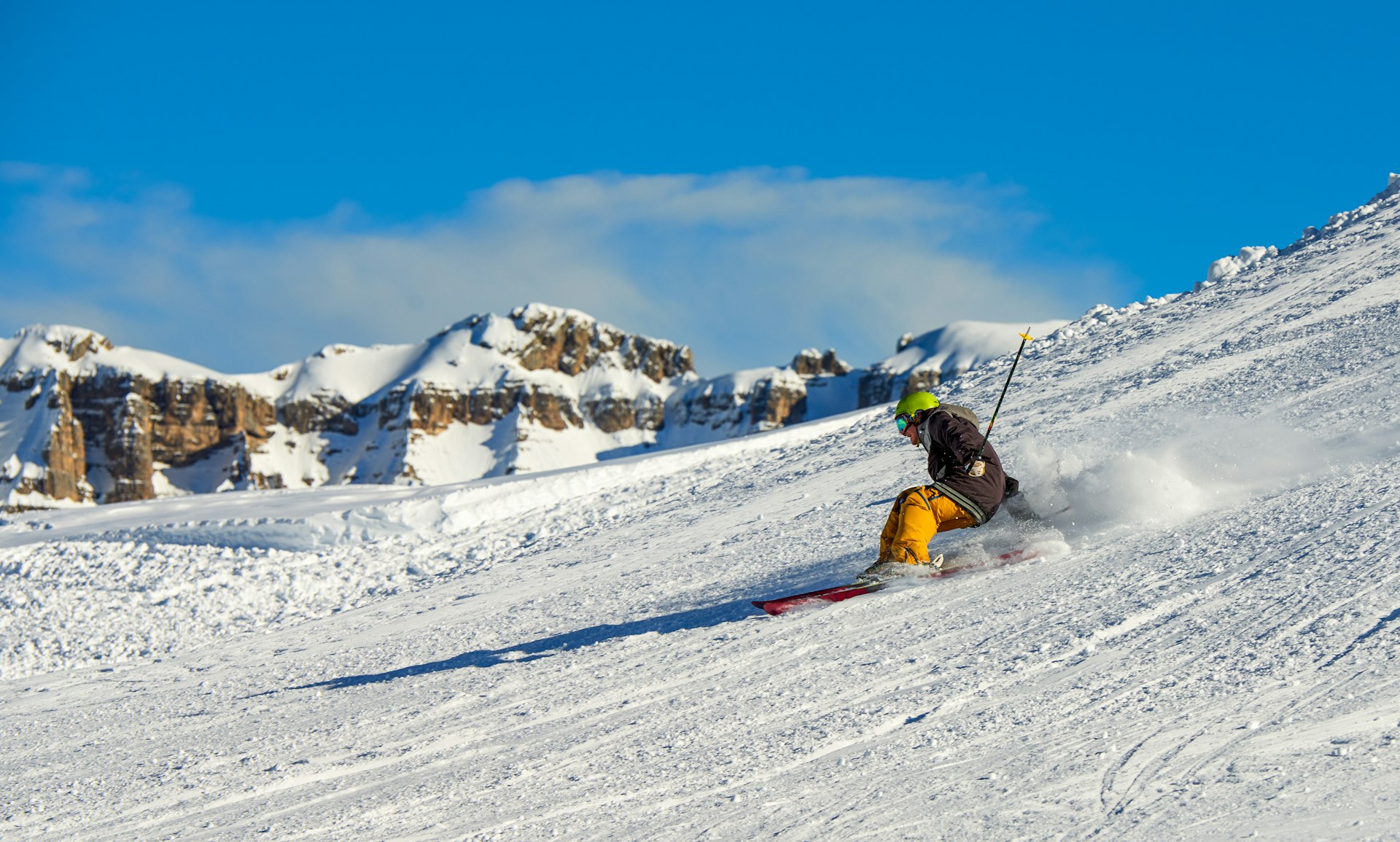 Skier rides down a slope at Madonna di Campiglio mountain ski resort.