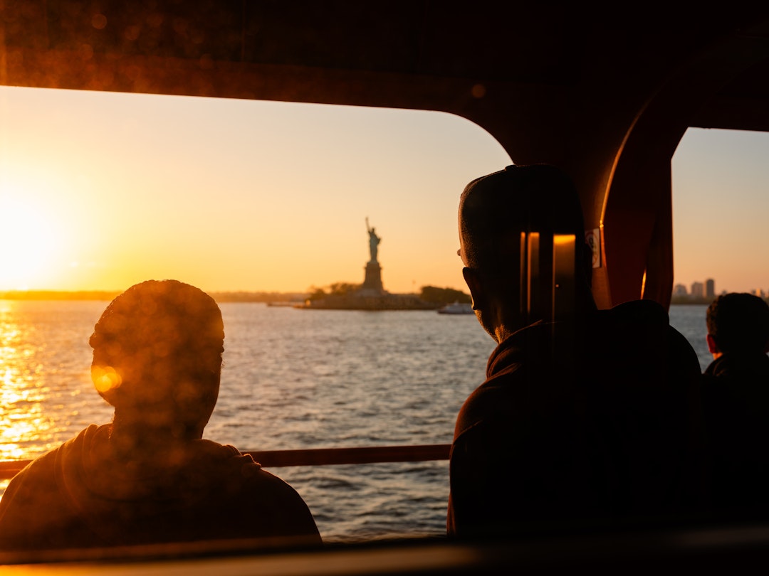 Anthony Nazario for Lonely Planet
The Staten Island Ferry from Staten Island, NY to Manhattan. Commuters and tourists enjoy the sun setting on the Statue of Liberty.