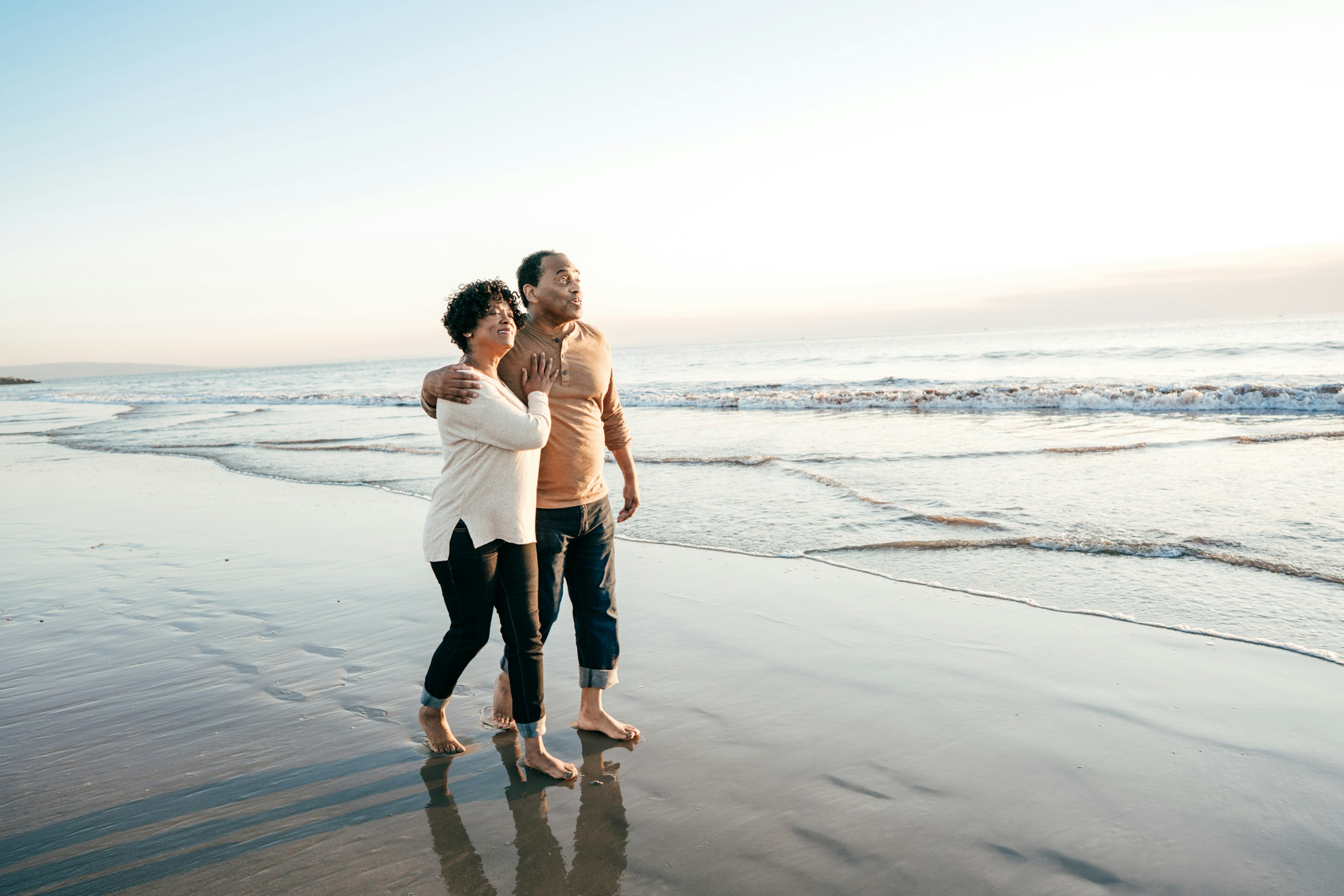 A Black couple walking along Tybee Beach in Georgia together