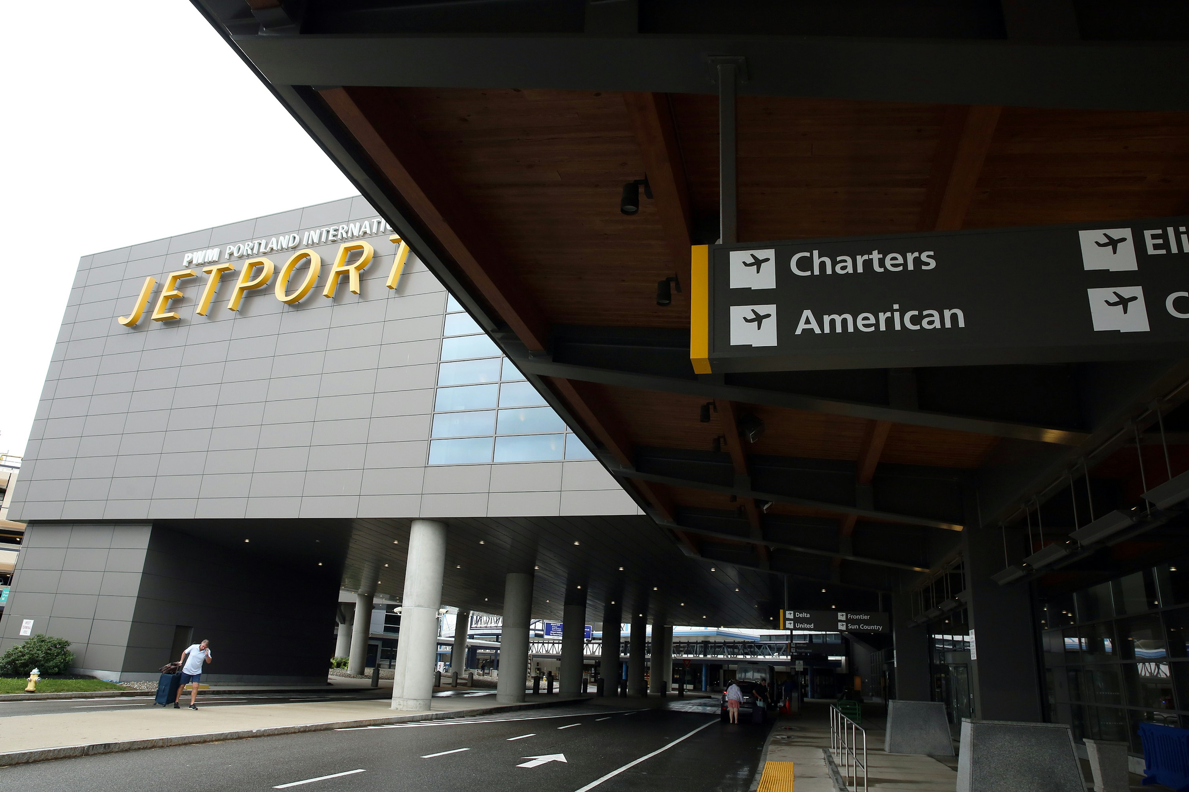 The exterior of an airport terminal building with the words