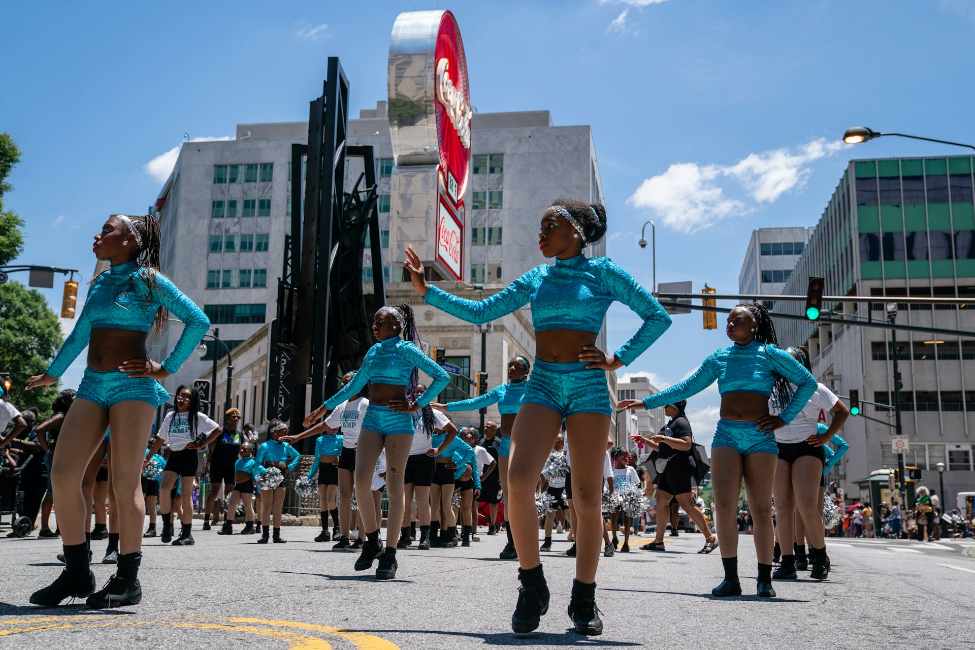 A group of dancers dressed in blue make their way through the streets of Atlanta for Juneteenth
