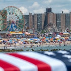 NEW YORK, NEW YORK - JULY 04: An American flag is hung as people celebrate the Fourth of July at Coney Island on July 4, 2021 in the Brooklyn borough of New York City. This year’s celebrations including, the annual Nathan’s hot dog eating contest, and the Macy’s 4th of July fireworks display, are happening at full capacity following smaller or mostly virtual celebrations in 2020 due to the coronavirus pandemic.  (Photo by Alexi Rosenfeld/Getty Images)
NEW YORK, NEW YORK - JULY 04: An American flag is hung as people celebrate the Fourth of July at Coney Island on July 4, 2021 in the Brooklyn borough of New York City. This year’s celebrations including, the annual Nathan’s hot dog eating contest, and the Macy’s 4th of July fireworks display, are happening at full capacity following smaller or mostly virtual celebrations in 2020 due to the coronavirus pandemic.  (Photo by Alexi Rosenfeld/Getty Images)
1326986618
independence day- us holidays, 4th of july, bestof, topix