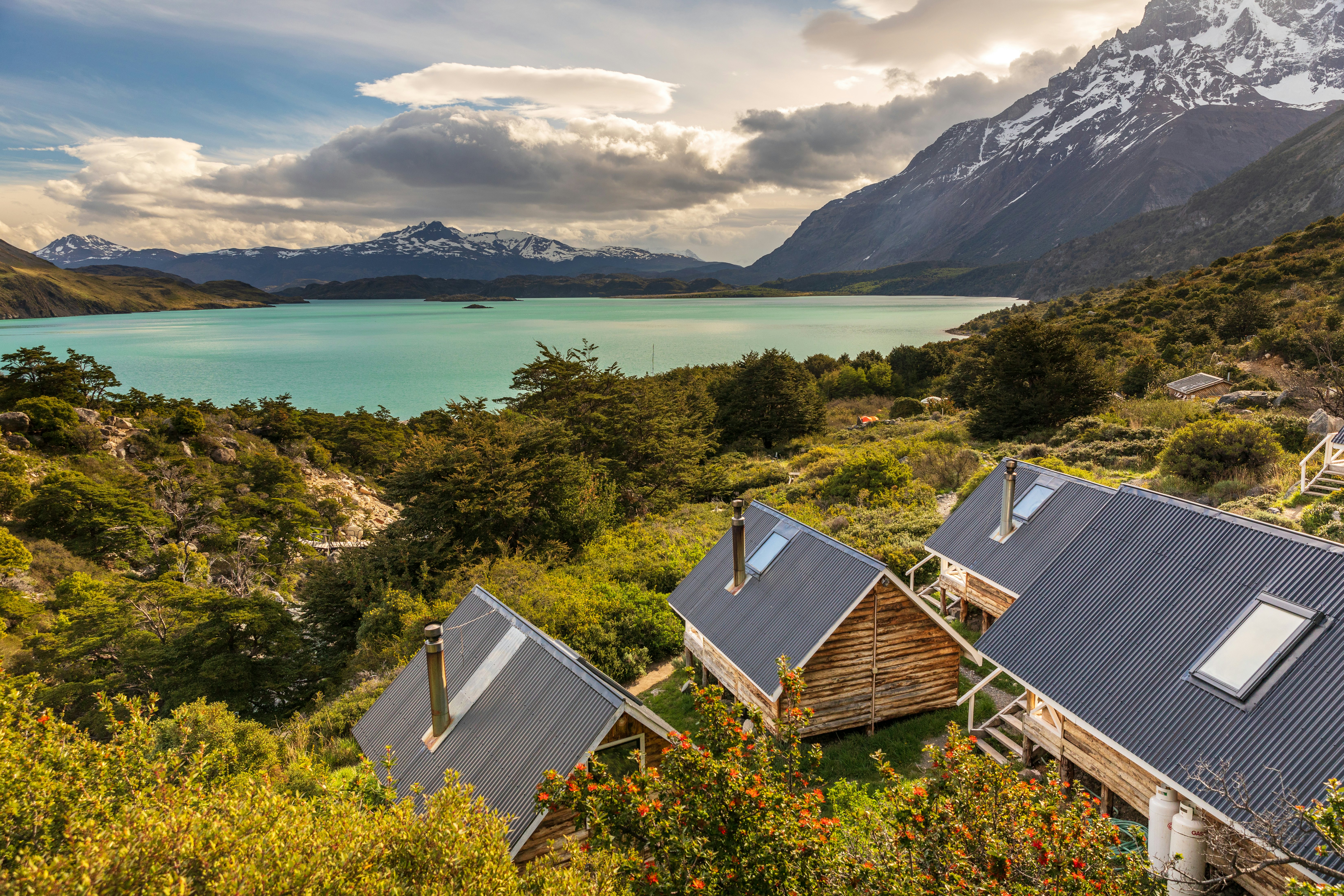 Wooden huts beside a lake in a mountainous area