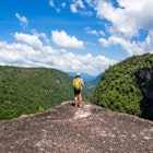 A women looks over the edge of Kaieteur Falls in Guyana
169646576