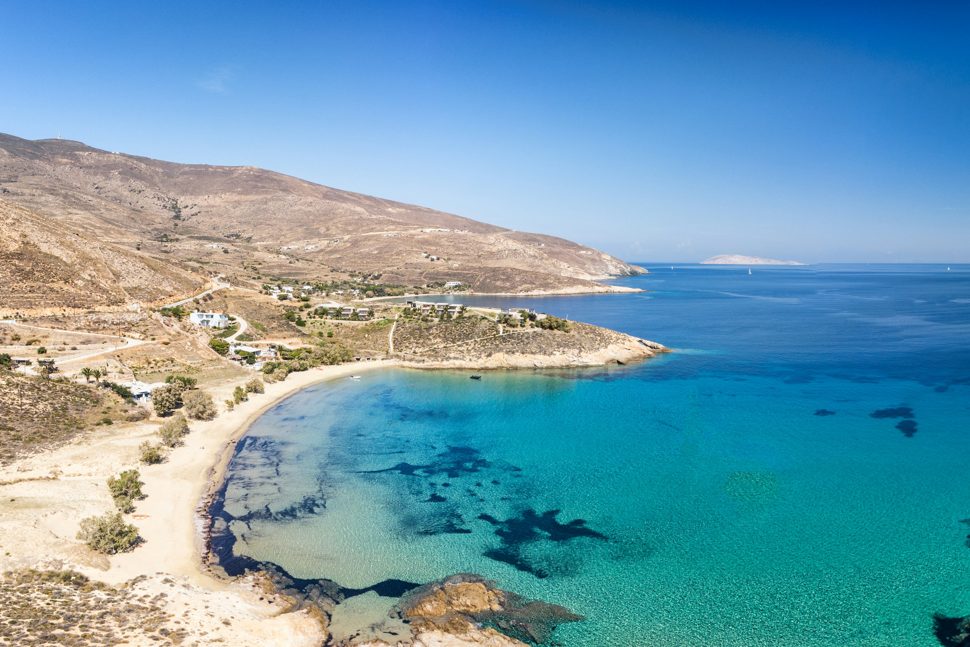 An empty beach with clear turquoise waters