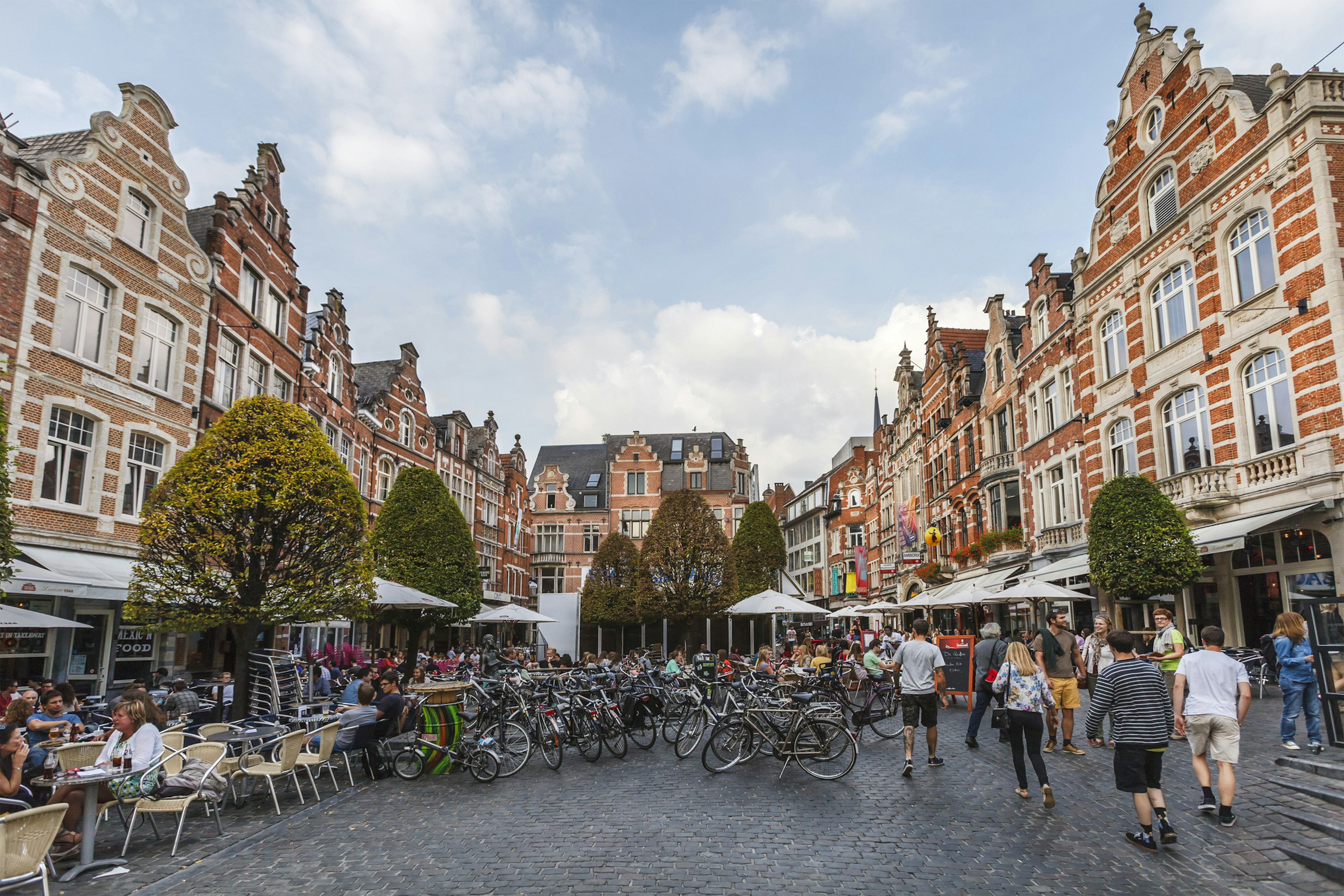 A cobbled square full of tables and chairs outside restaurants