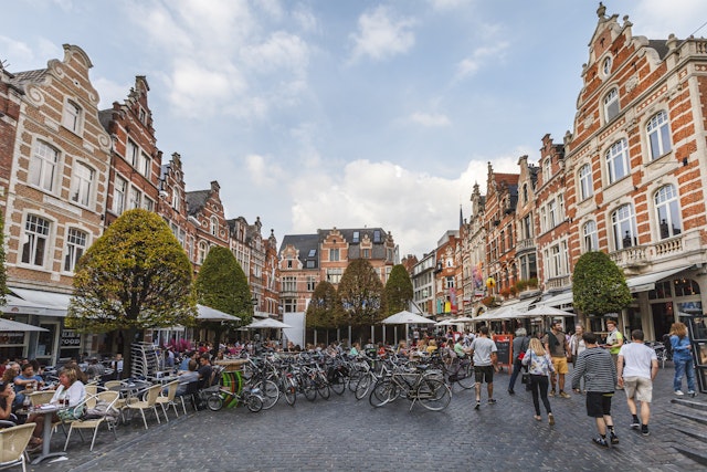 A cobbled square full of tables and chairs outside restaurants