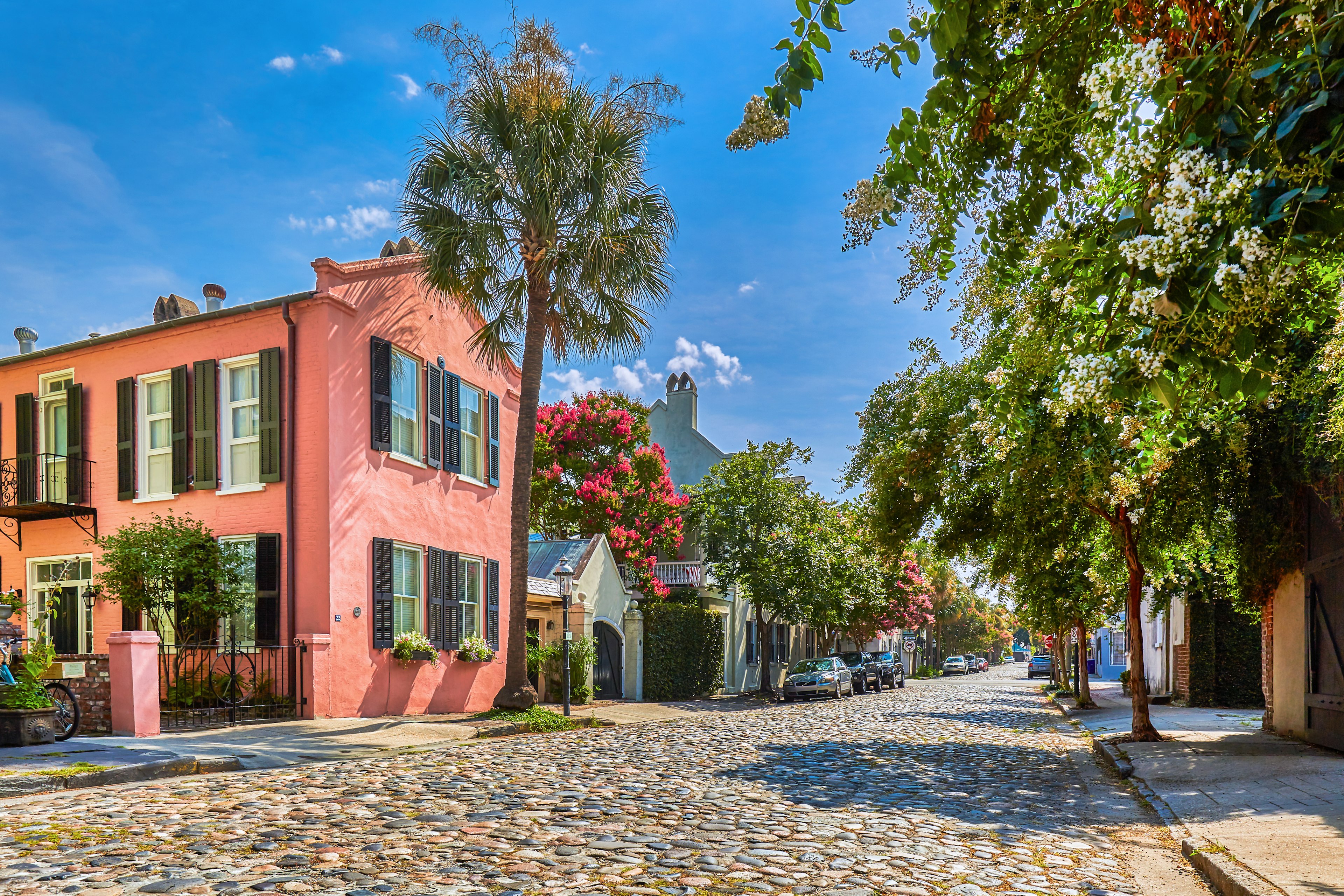 A cobbled street lined by pastel-colored historic houses