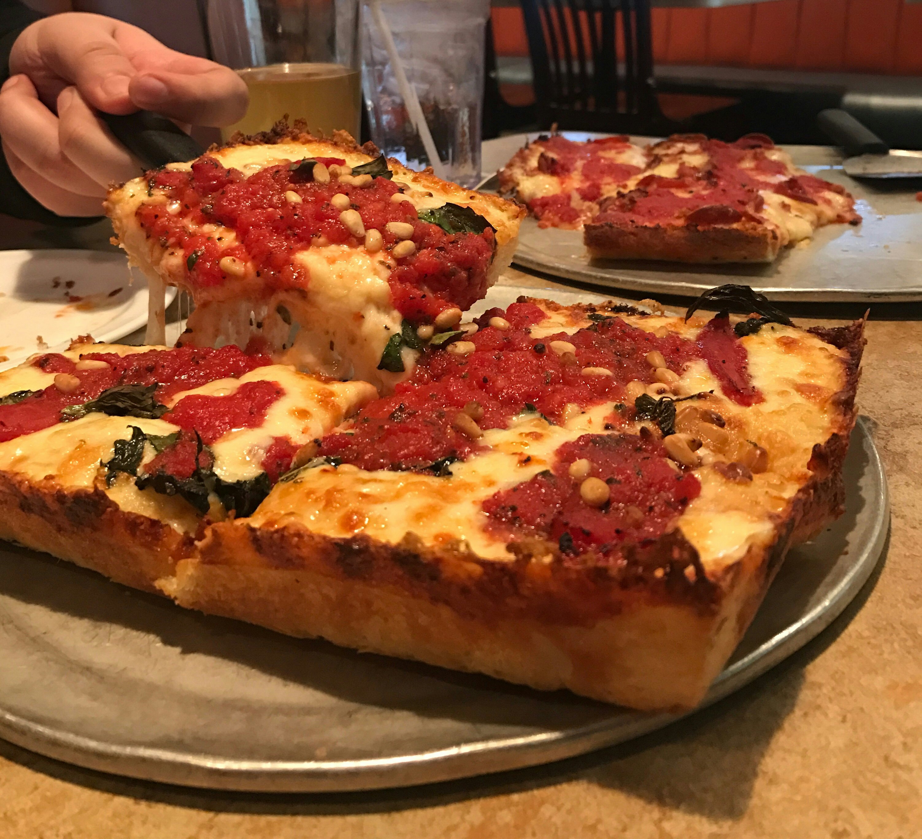 Serving Detroit style pizza hot from the oven with melted cheese and tomato sauce
864317074
Serving Detroit style pizza - stock photo
Serving Detroit style pizza hot from the oven with melted cheese and tomato sauce