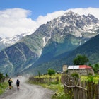 Hikers walking on dirt road at Cholashi village, Zemo Svaneti region, Caucasus mountain, Georgia.