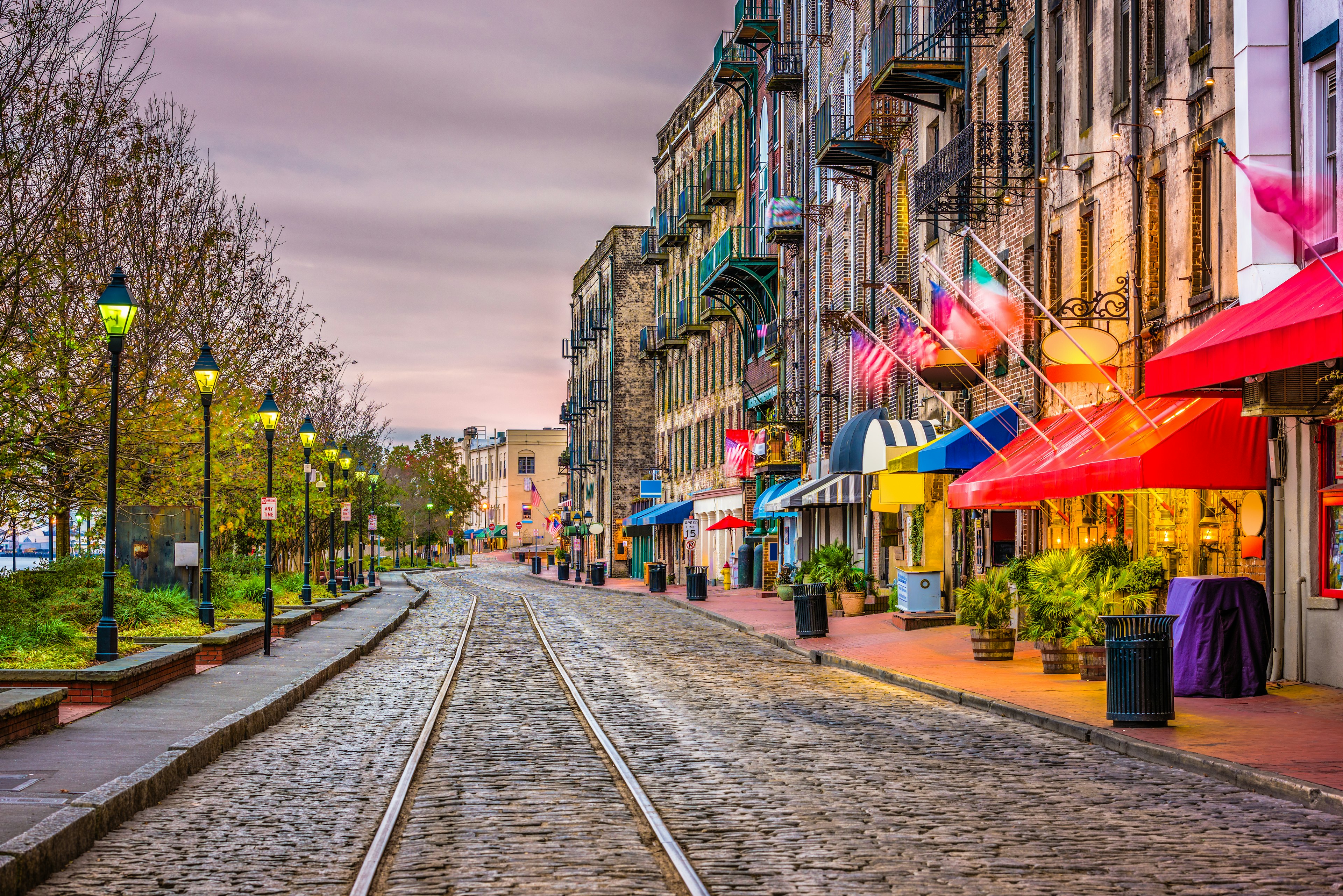 Streetcar tracks, restaurants and bars on River Street, Savannah