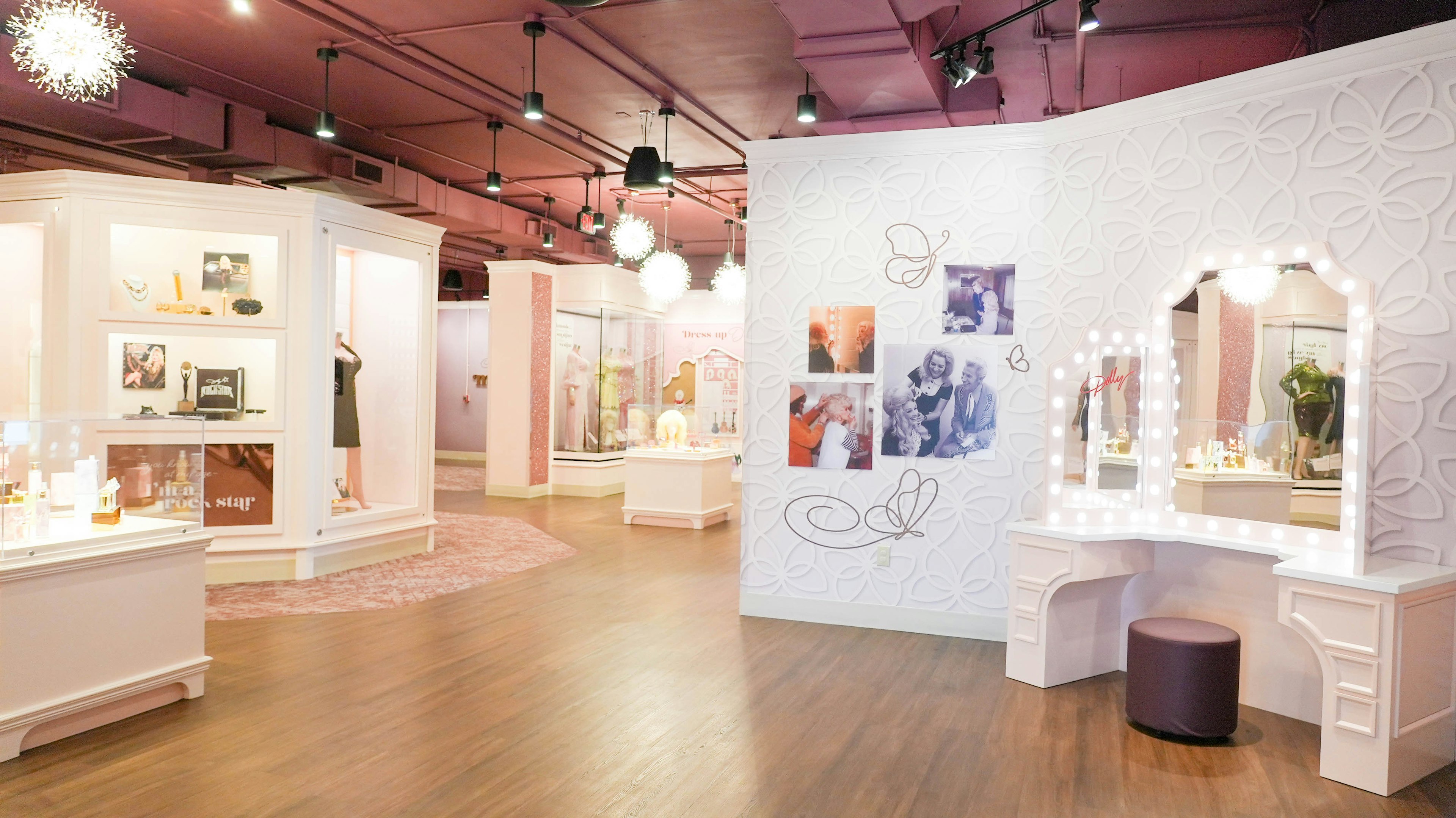 An exhibit of family photographs, a dressing table and clothing